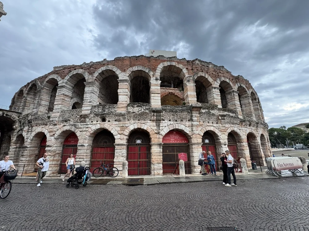 Verona Arena ancient Roman amphitheater beneath dramatic storm clouds