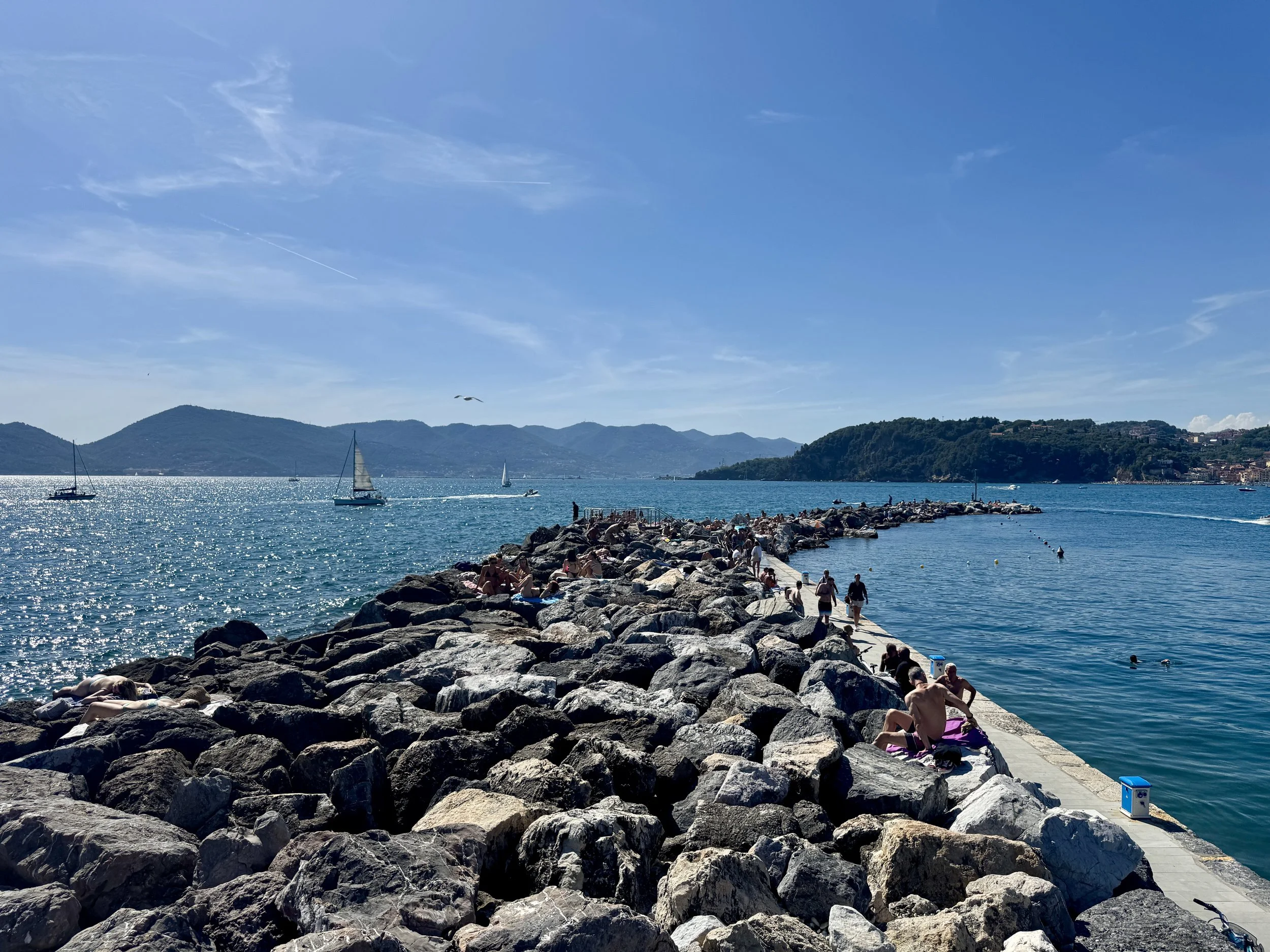 Rocky breakwater and sailboats on the Gulf of Poets