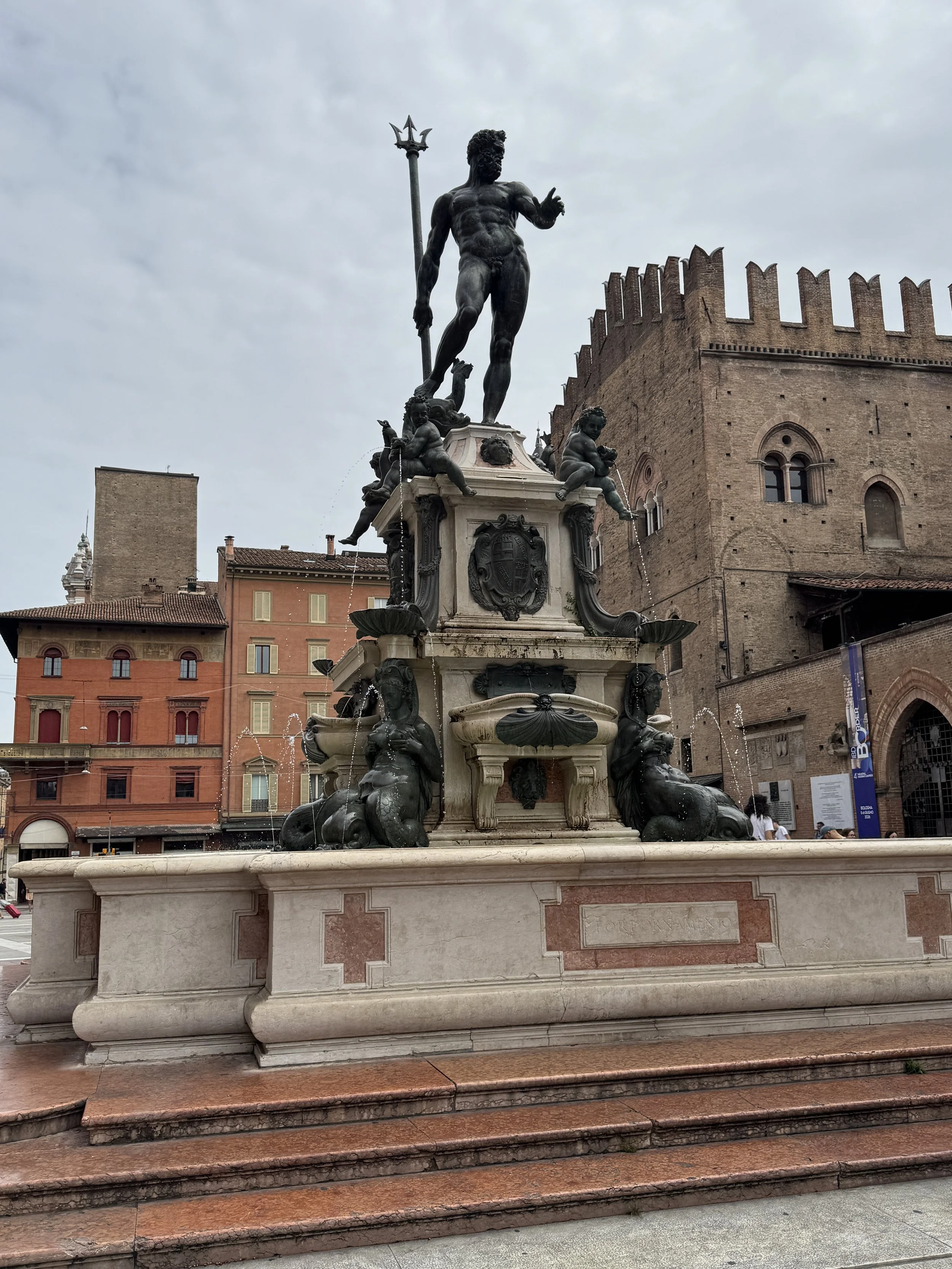 Neptune Fountain and surrounding medieval buildings in Bologna's Piazza Maggiore.