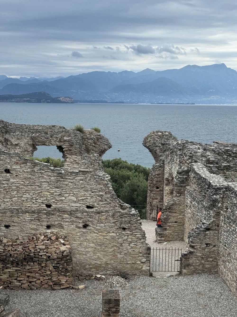 Ancient Roman villa walls framing Lake Garda at Grotte di Catullo in Sirmione