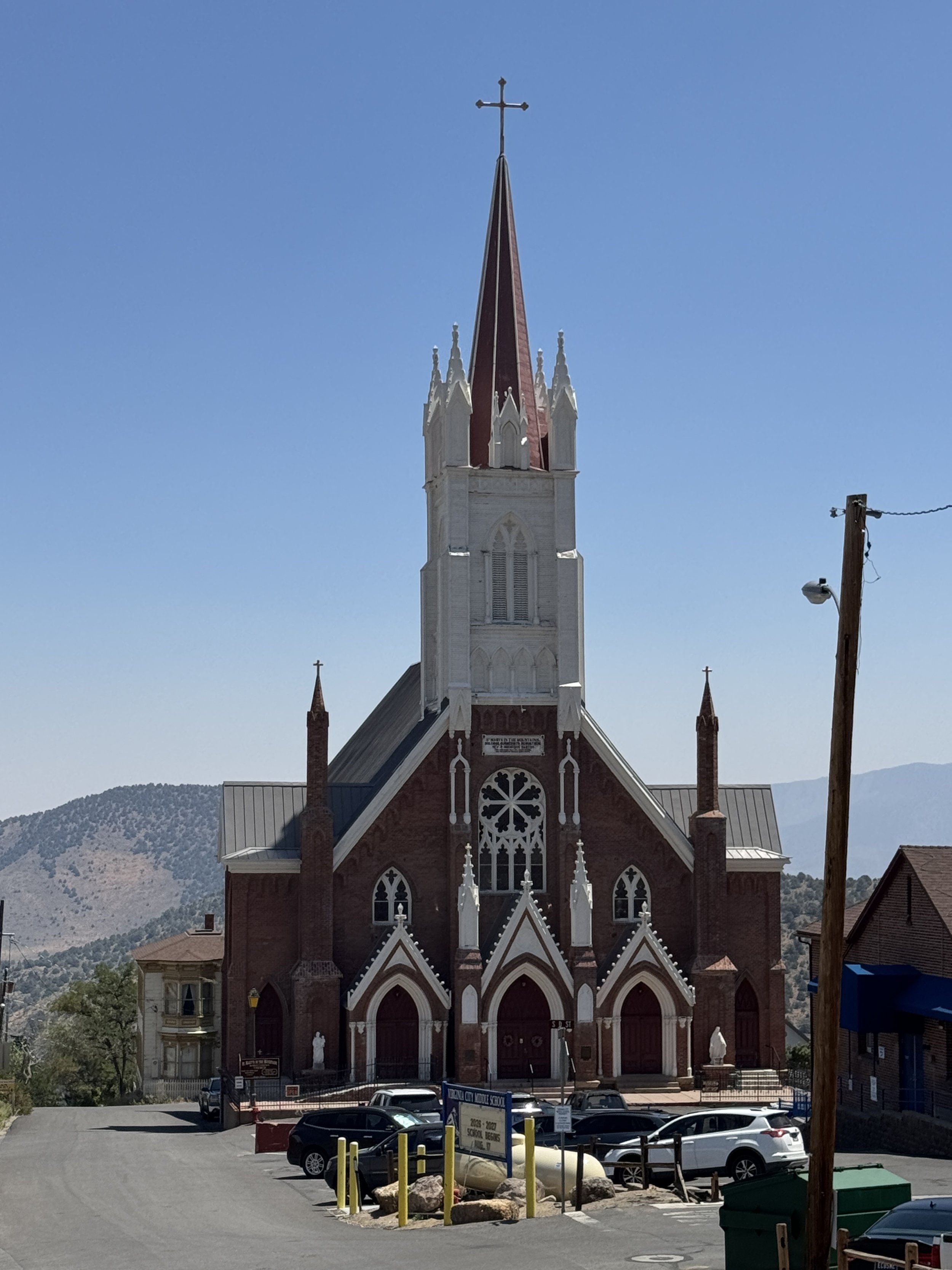 Historic Saint Mary in the Mountains Catholic Church beneath a clear blue sky in Virginia City, Nevada.