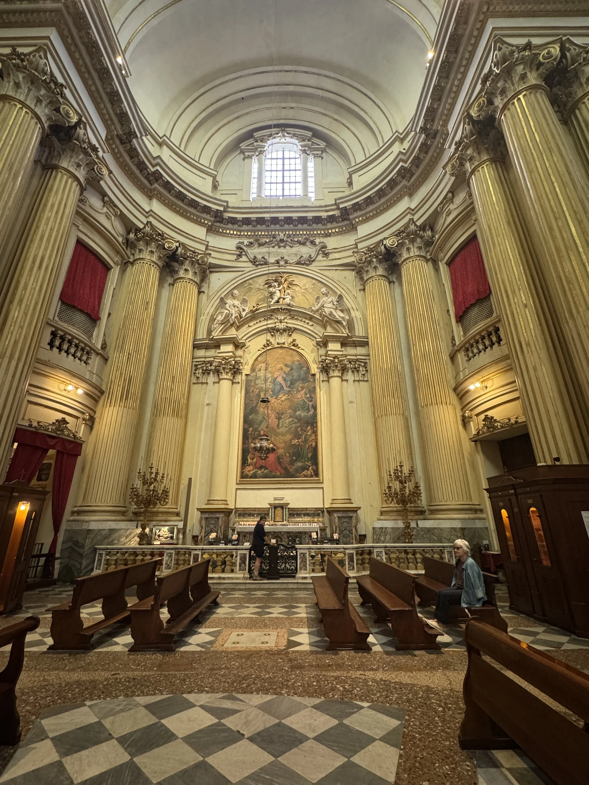 Side chapel inside the Sanctuary of the Madonna di San Luca framed by gilded columns.