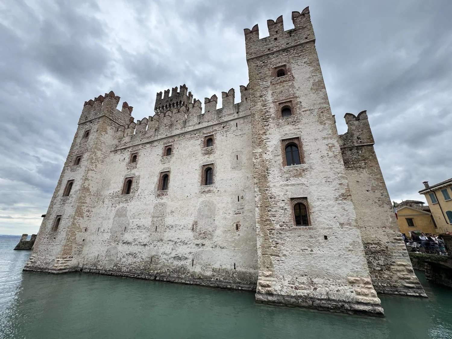 Medieval stone walls and crenellated towers of Scaliger Castle in Sirmione