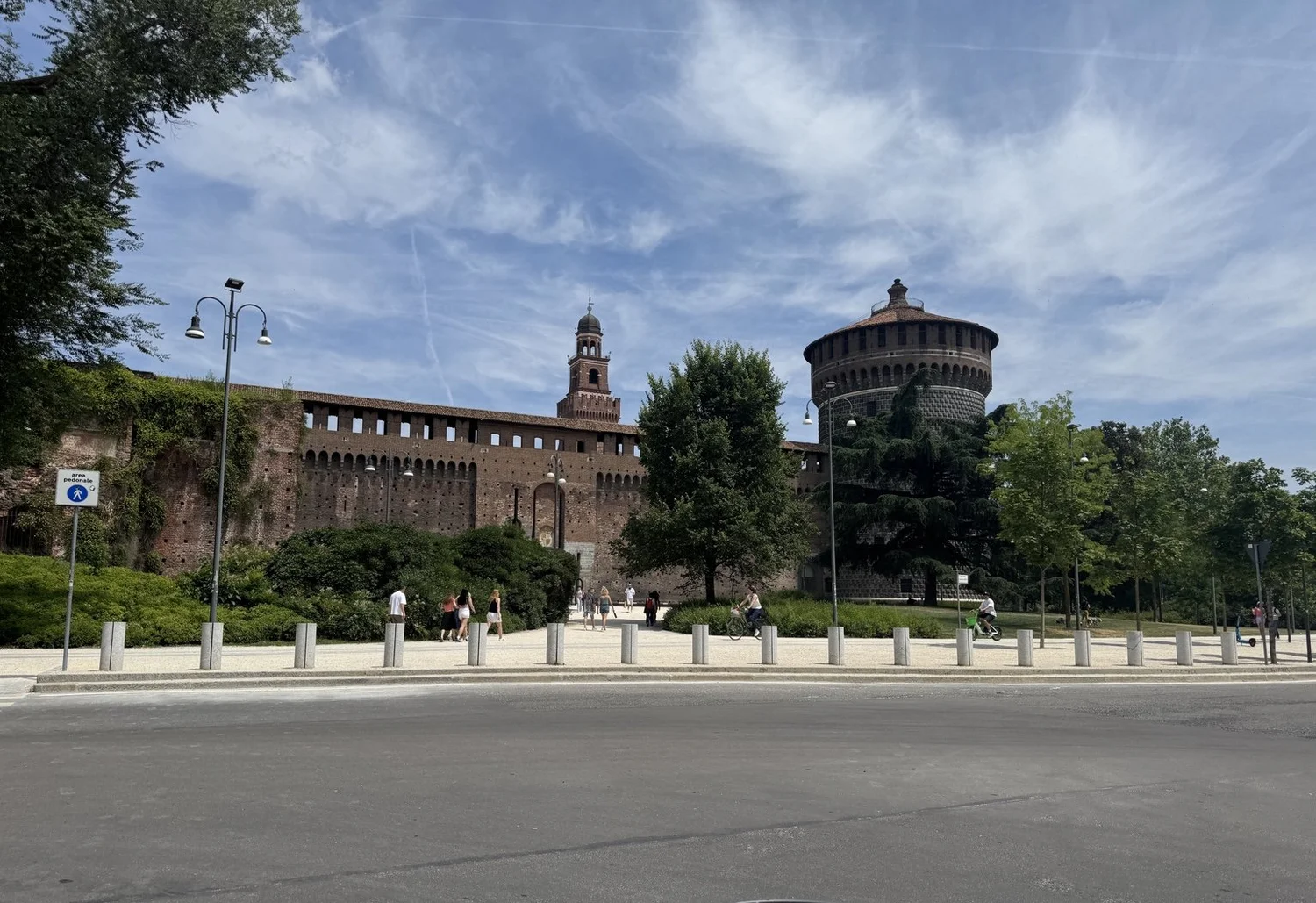 Exterior brick walls and round defensive tower of Castello Sforzesco in Milan