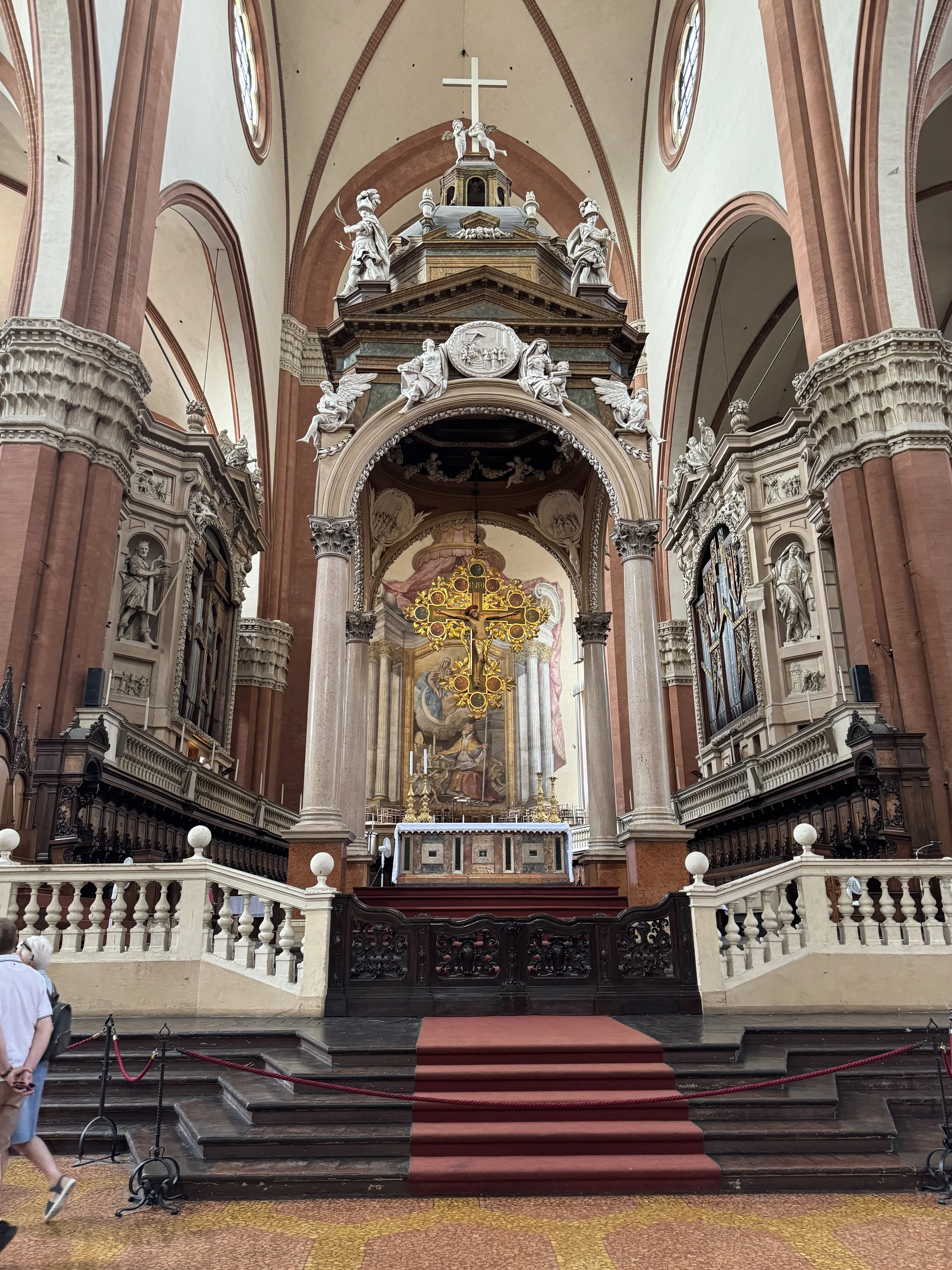 Decorated altar and red-carpeted steps inside the Basilica di San Petronio.