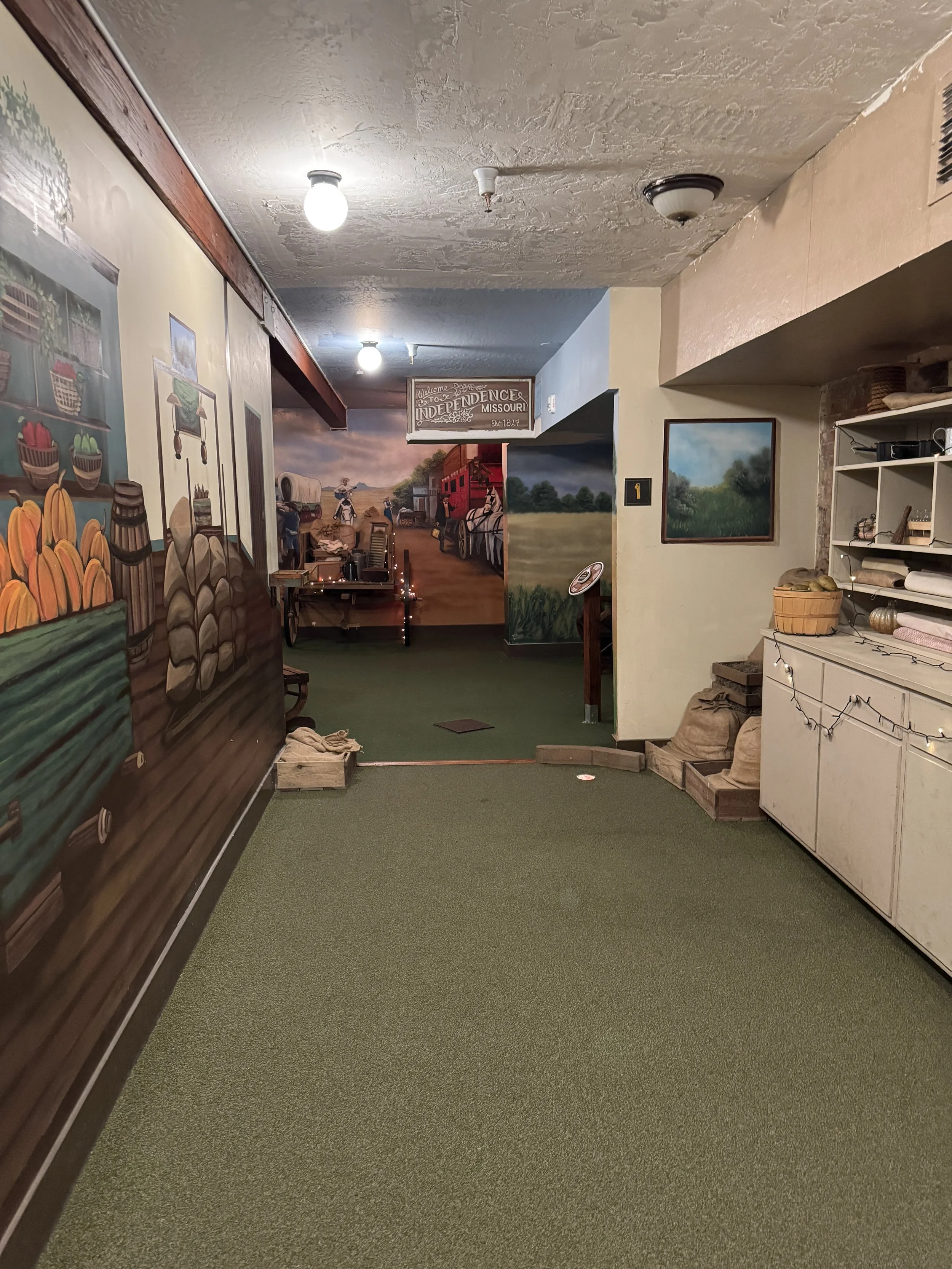 Old West-themed underground miniature golf course with painted murals and historic-style props in Old Sacramento.