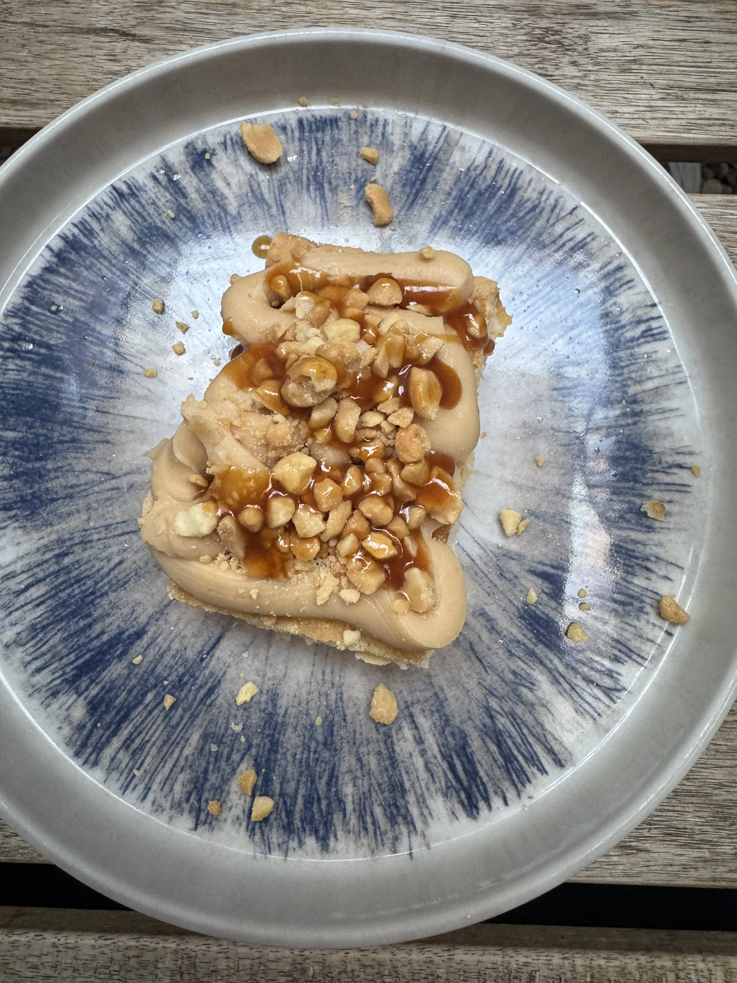 Salted caramel dessert topped with peanuts at Cru in Florence.