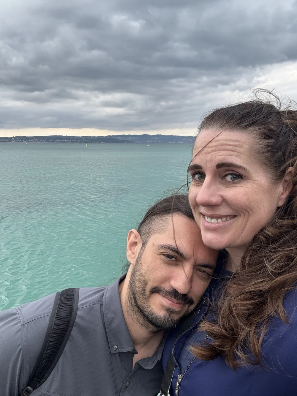 Couple overlooking the turquoise water of Lake Garda in Sirmione, Italy