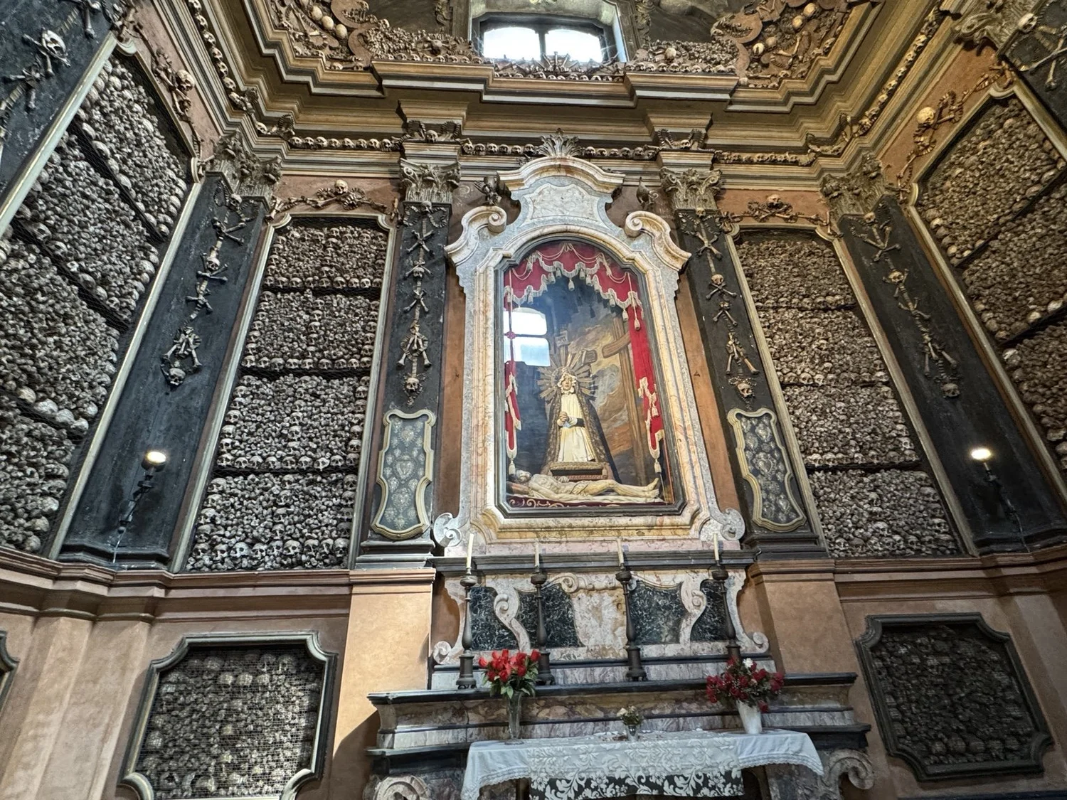 Bone-covered altar and ossuary walls inside San Bernardino alle Ossa in Milan, Italy