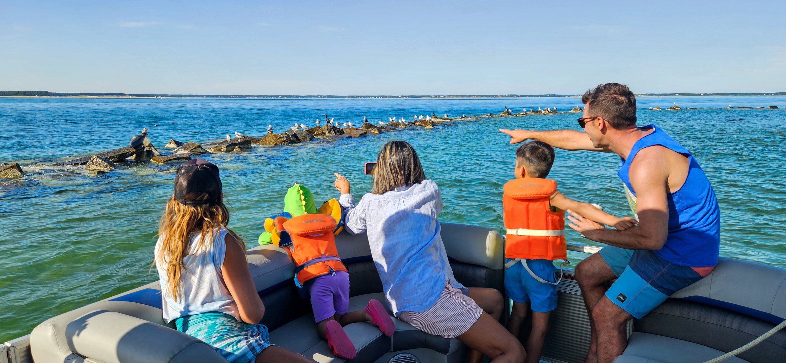 Family watching seals from a private boat in Wellfleet Harbor