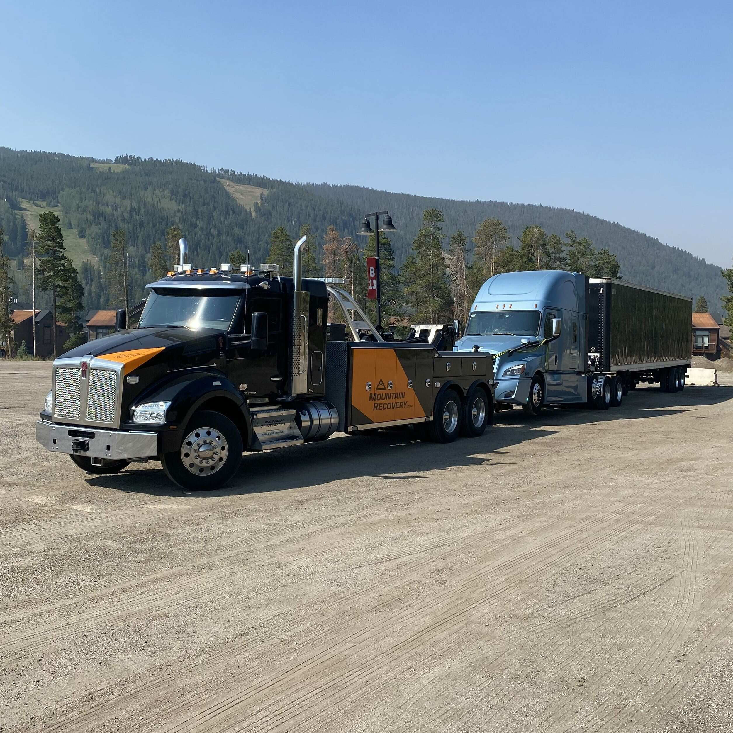 Mountain Recovery heavy-duty tow truck towing a commercial tractor-trailer in Colorado