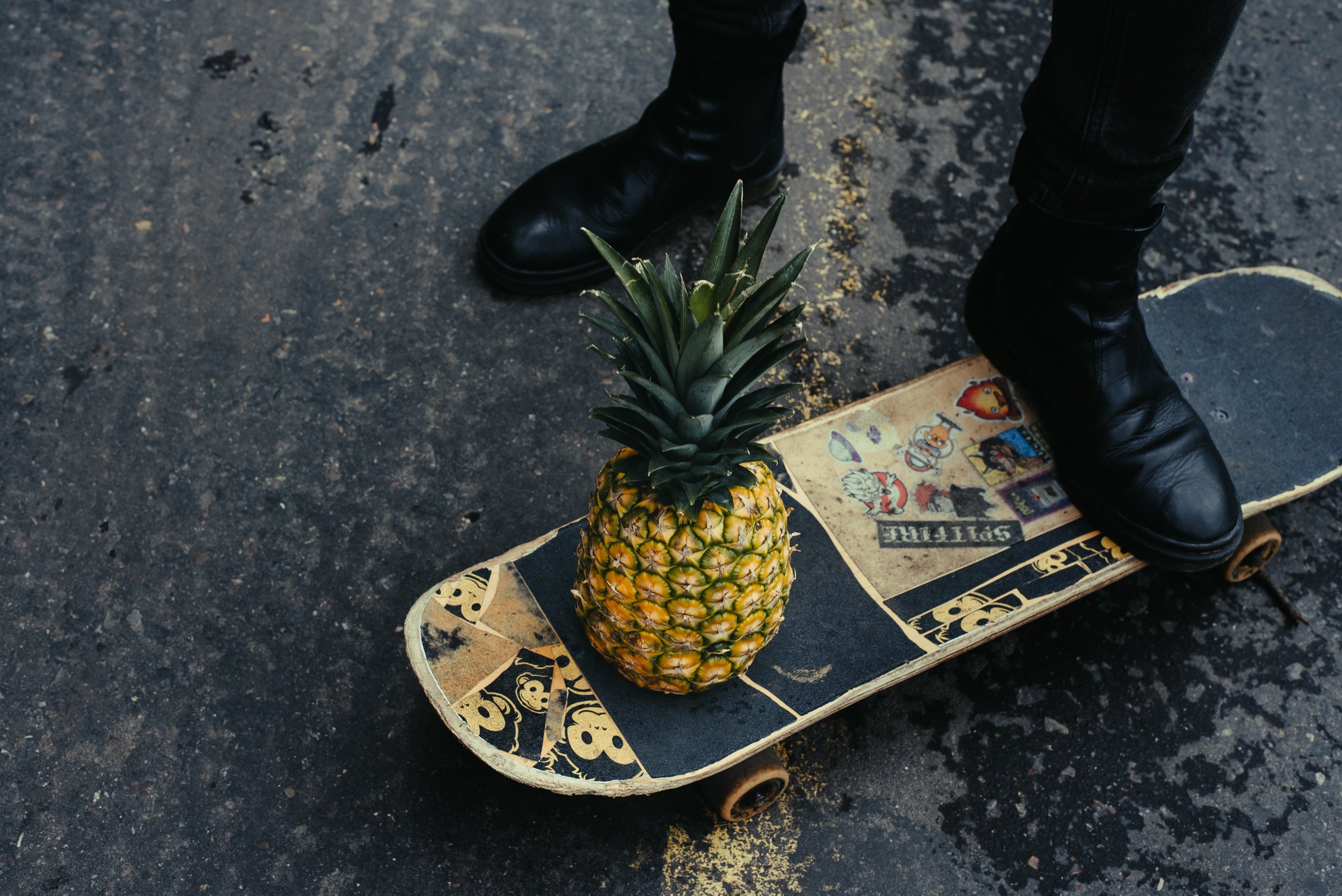Piña sobre patineta con botas en carretera — detalle creativo Mauricio Candela