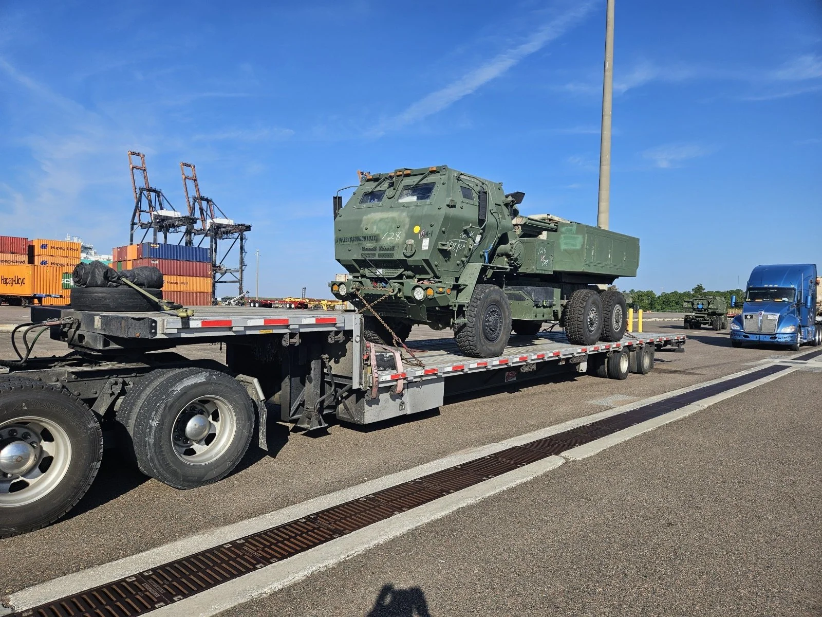 BAR Transportation blue Kenworth hauling six industrial pressure vessels on step-deck