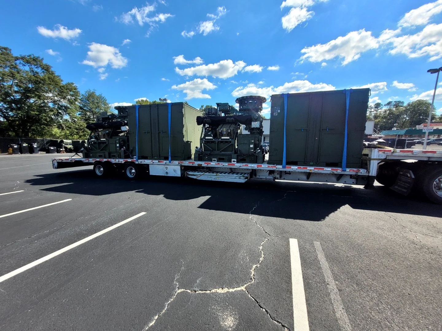 BAR Transportation white Kenworth with artillery at naval waterfront facility