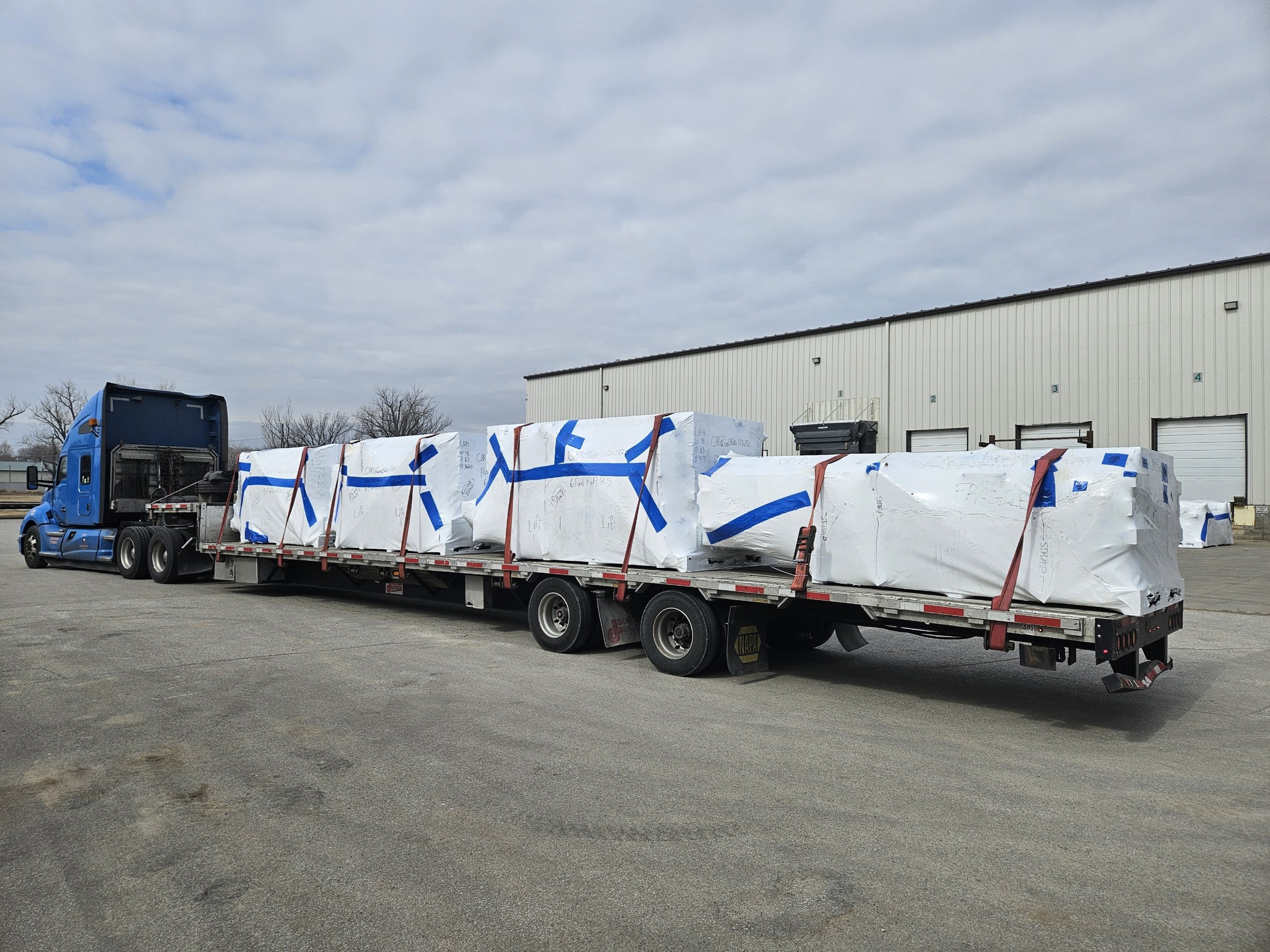 BAR Transportation blue Kenworth with stacked USAU military ISO containers