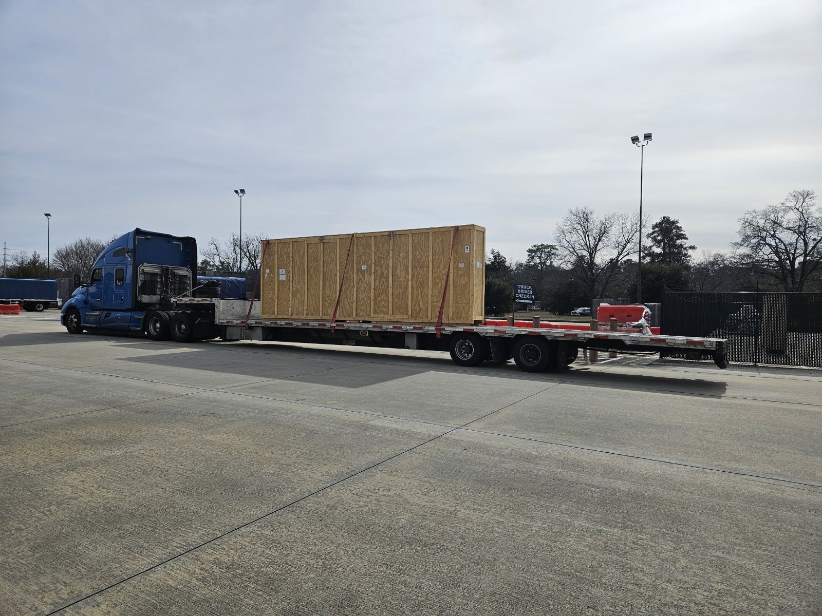 BAR Transportation blue Kenworth hauling two military yard tractors on step-deck
