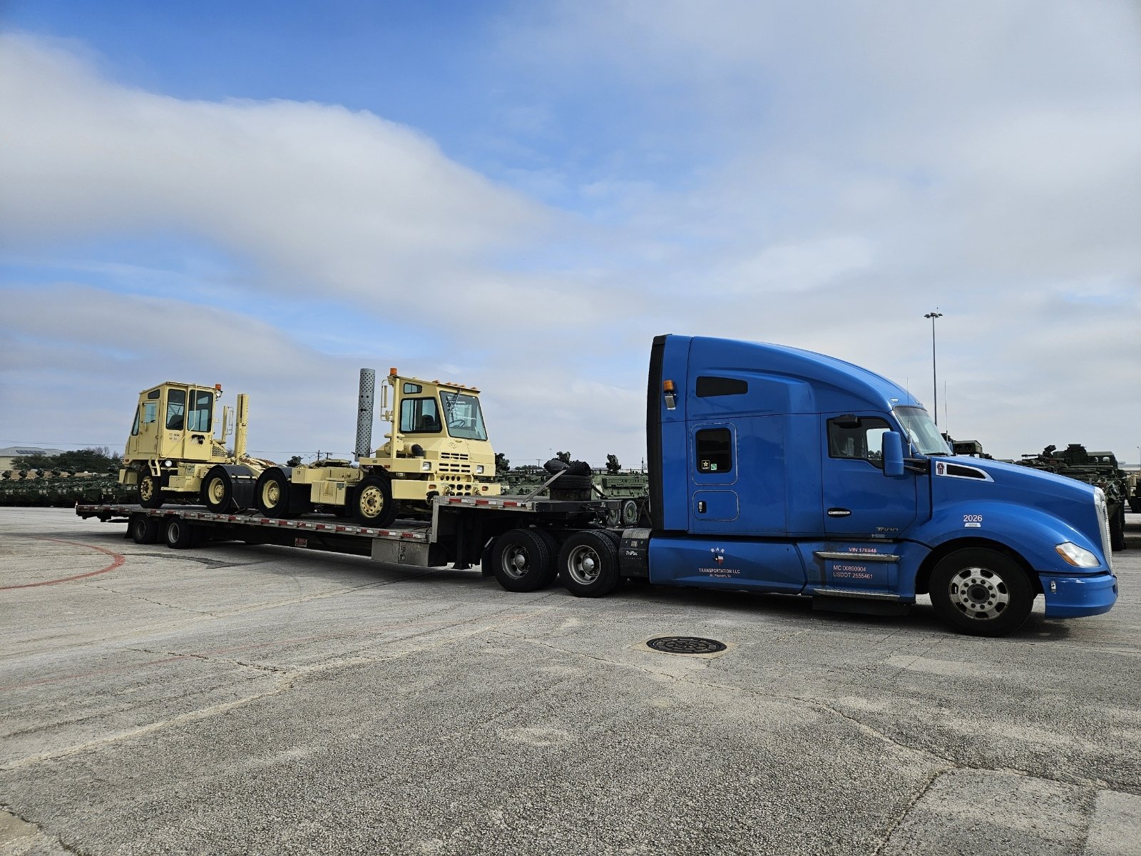 BAR Transportation blue Kenworth with wrapped machinery components on flatbed