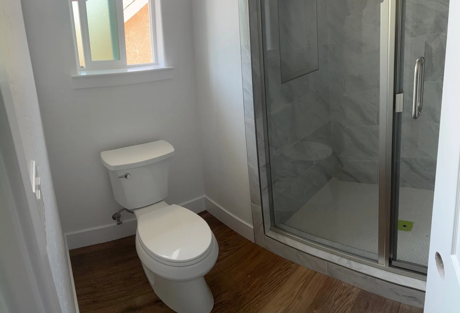 Hall bathroom with tiled walk-in glass shower — custom home, Fresno, CA