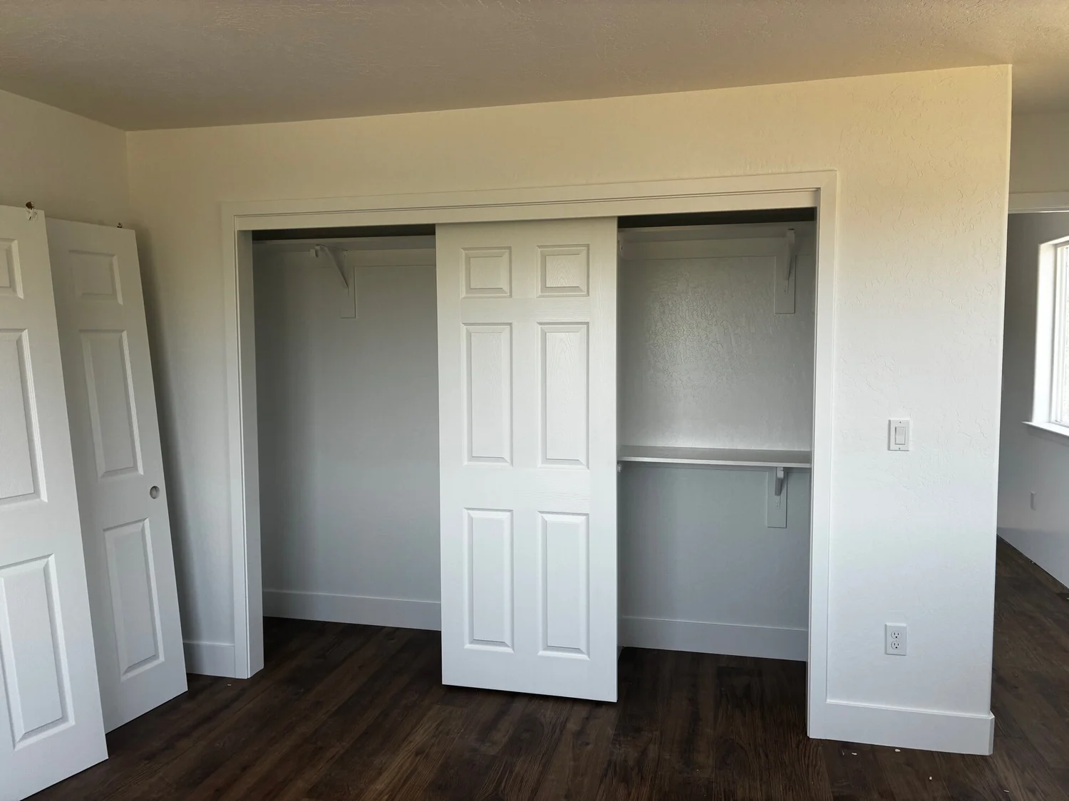 Finished bedroom with built-in closet and wood-look flooring — Fresno, CA