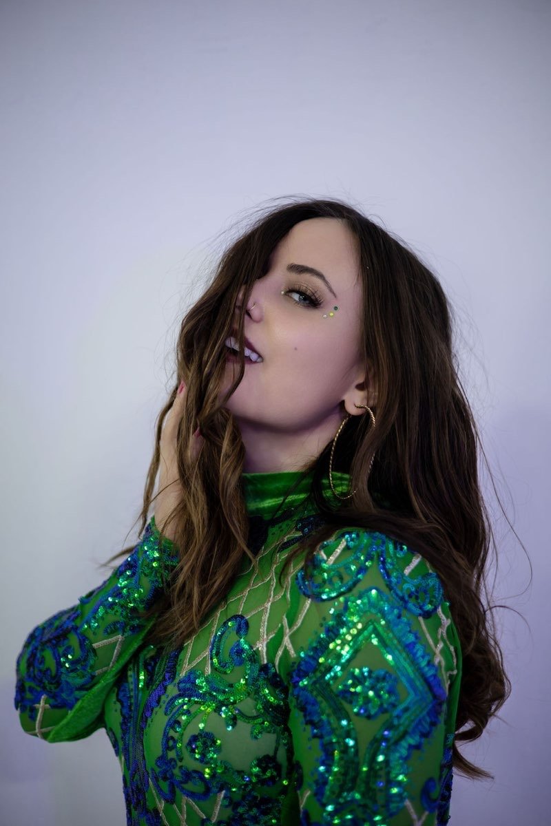Brittany Crystal wearing a green and blue embellished outfit