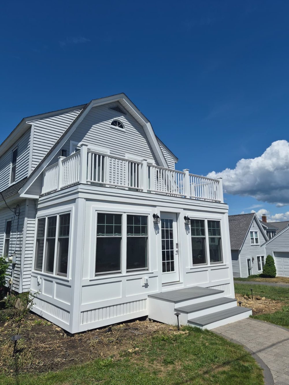 Enclosed 3-season porch with rooftop deck above
