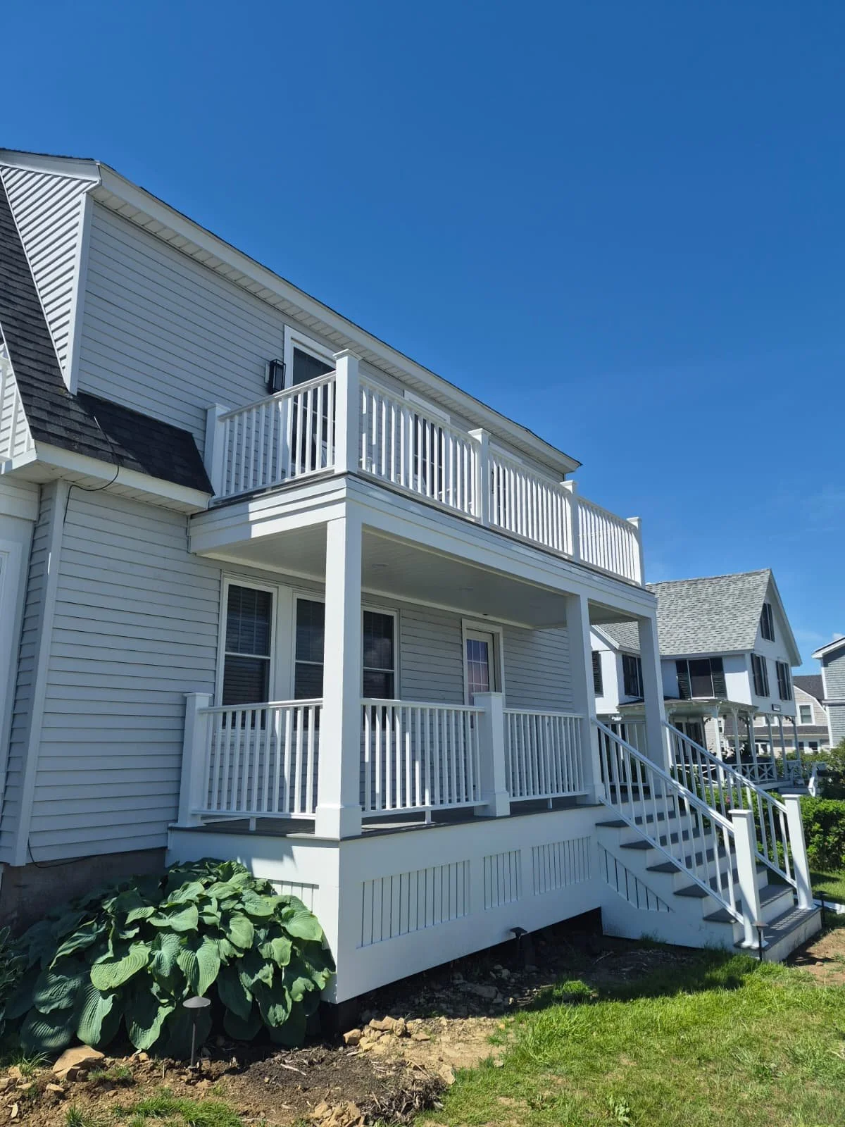 Finished two-level open porch with exterior stair, walking out from both floors, York ME