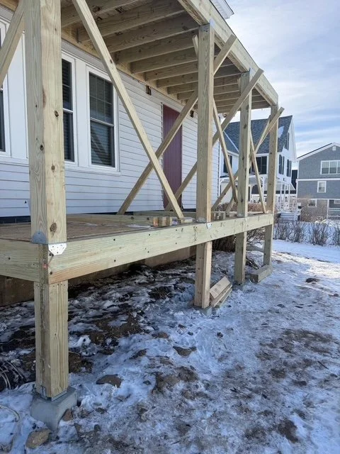 Enclosed porch framed and wrapped against the weather during the winter build, York ME