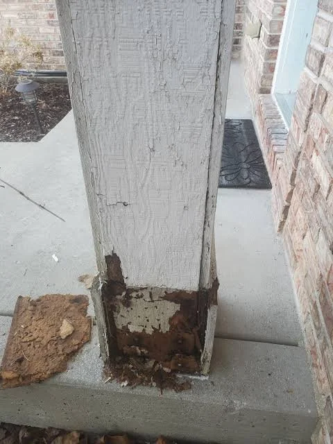 Porch post with rot and peeling paint at its base