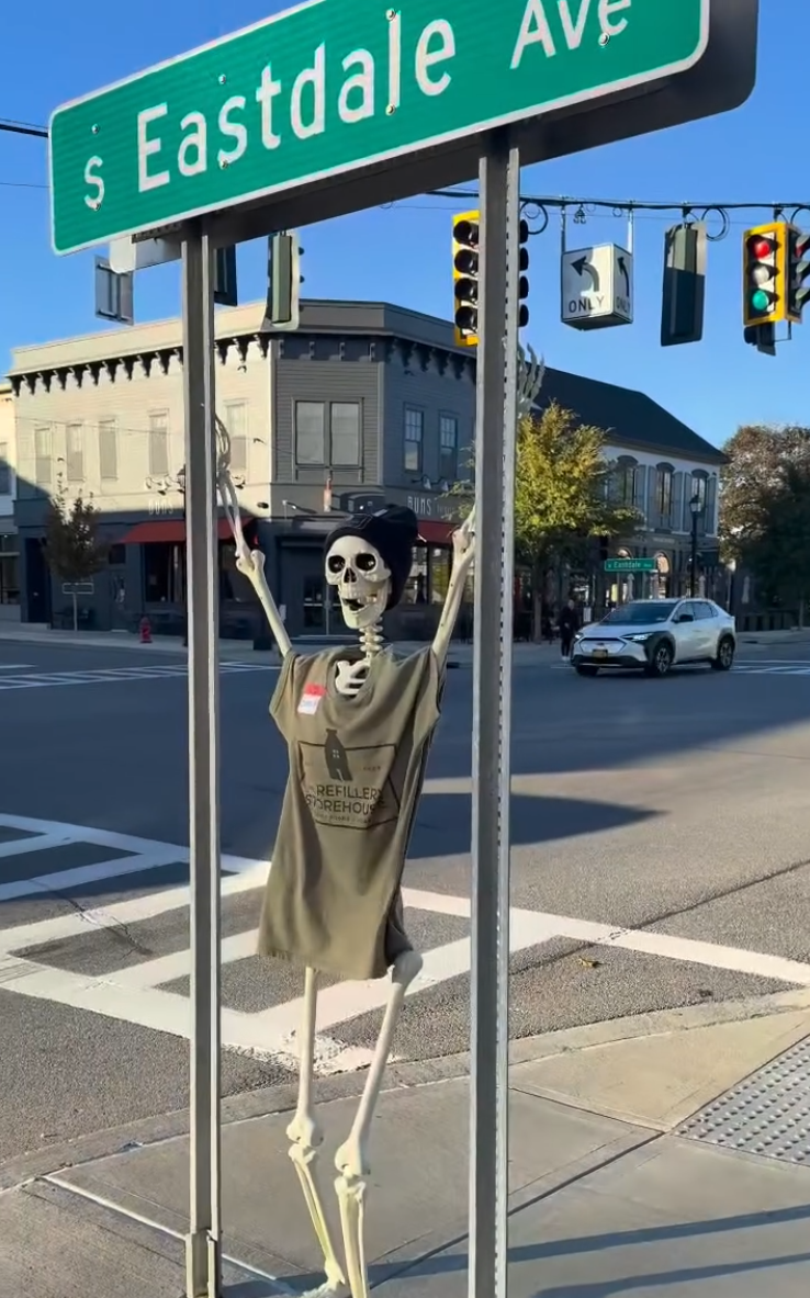 A skeleton hangs beneath the South Eastdale Avenue street sign at Eastdale Village.