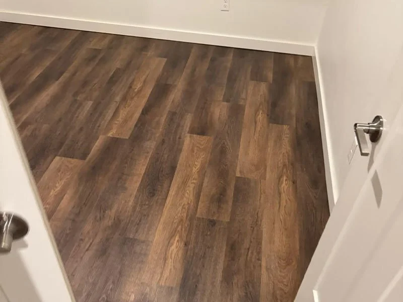Handyman repairing damaged laminate flooring in Oklahoma