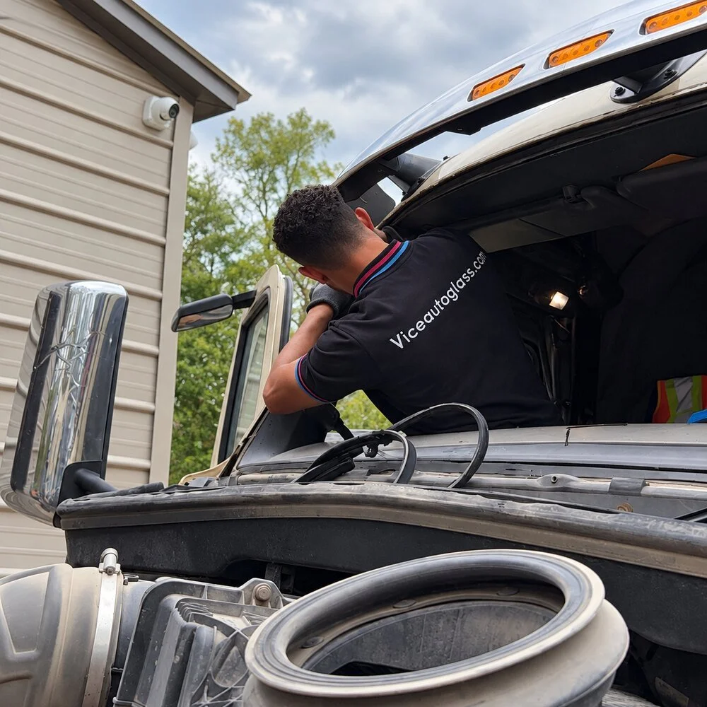 Vice Autoglass technician working on a commercial truck windshield opening