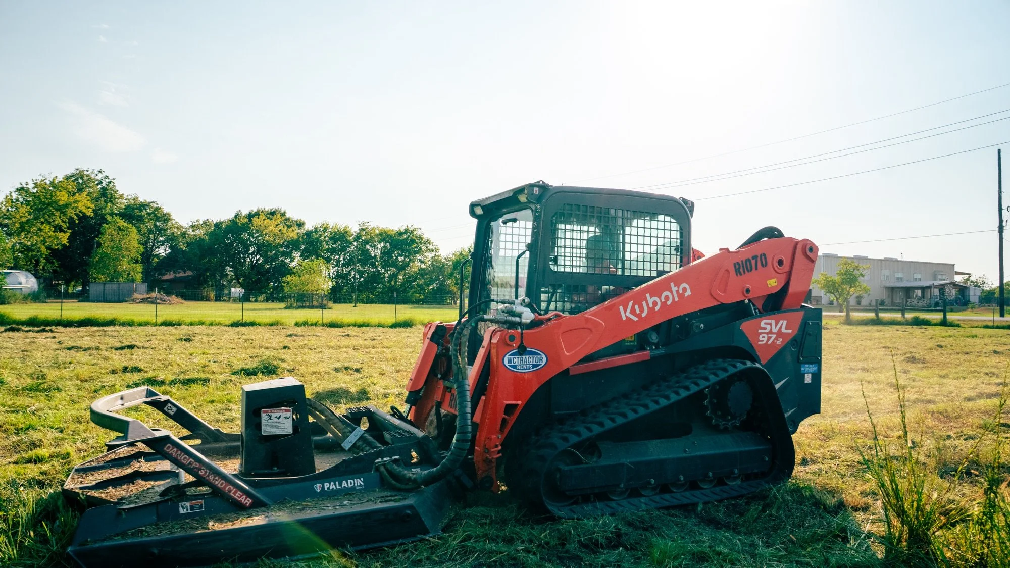Kubota SVL97-2 skid steer with a brush-cutter attachment on a Farmer Brown project