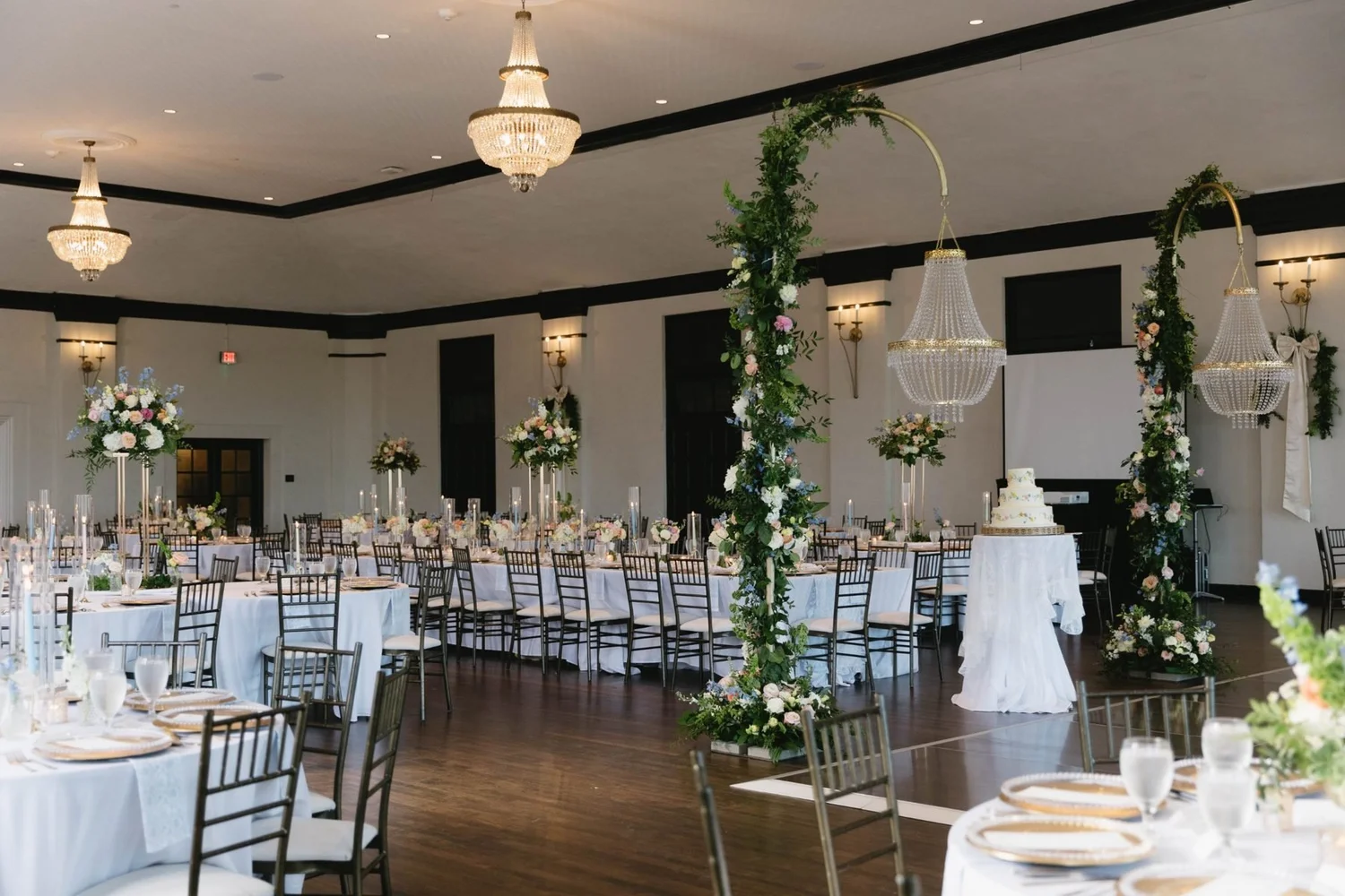 The ballroom with hoop installations, tall centerpieces and long tables