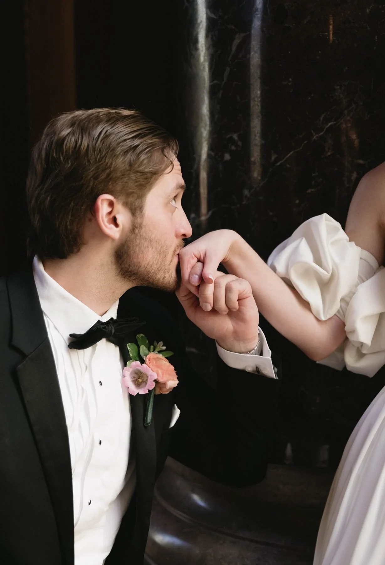 Boutonniere of ranunculus and campanula on a black tuxedo
