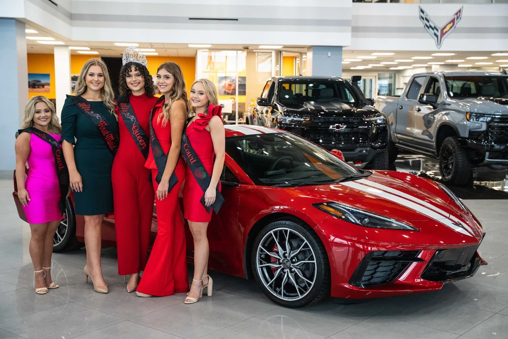 Strawberry Festival court with a red Corvette at Stingray Chevrolet