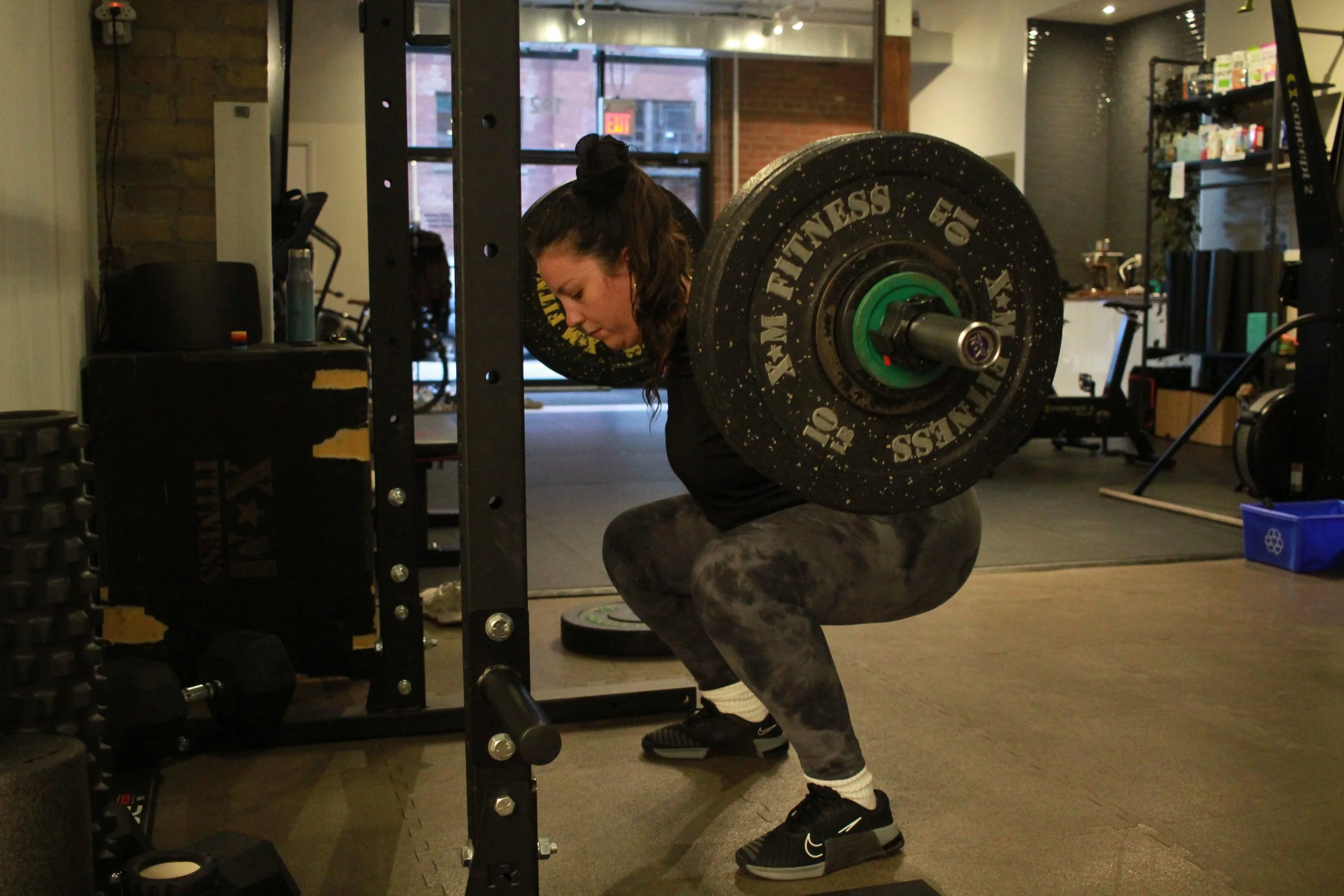Empact female member back squatting heavy weights