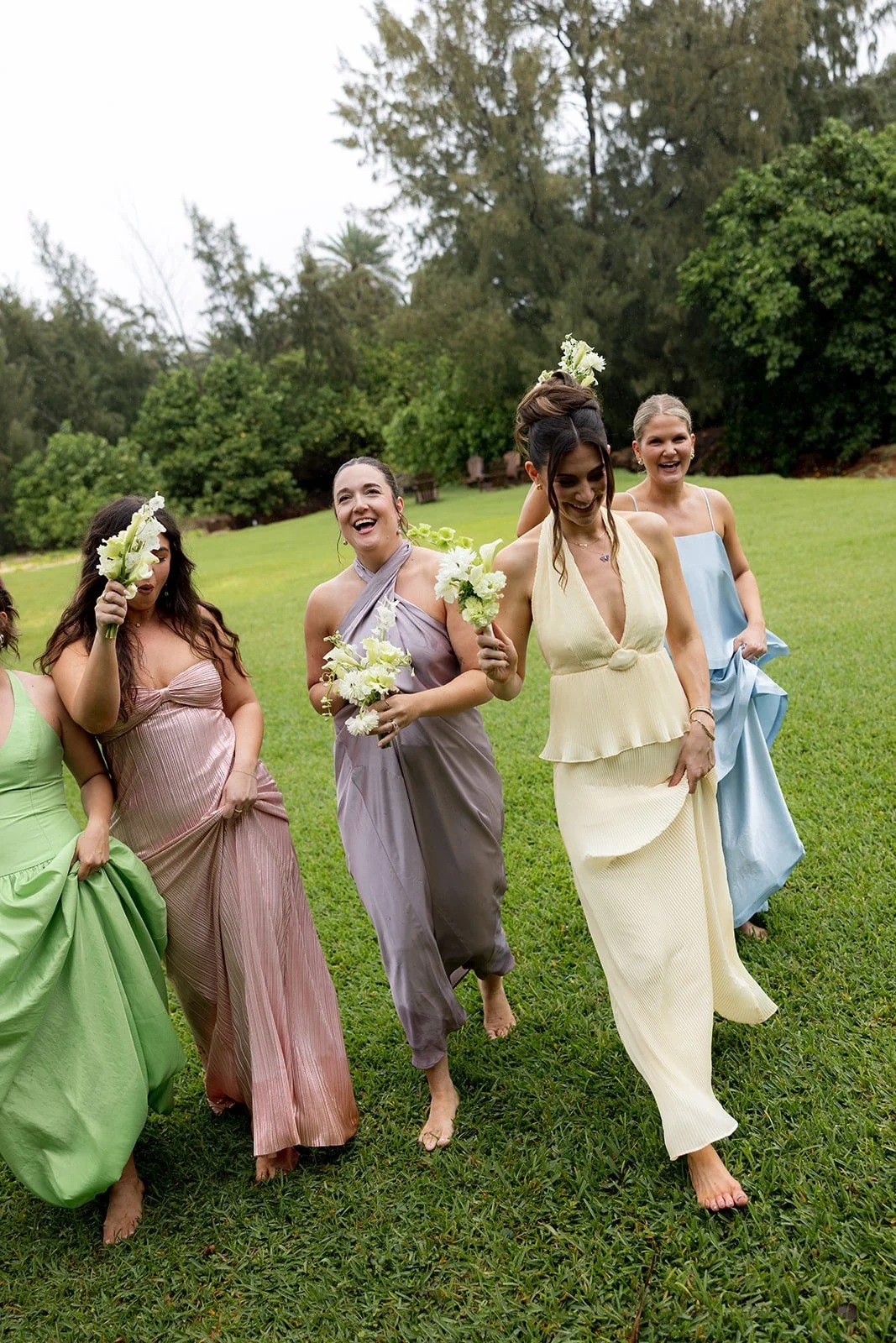 Bridesmaids holding bouquets in pastel dresses
