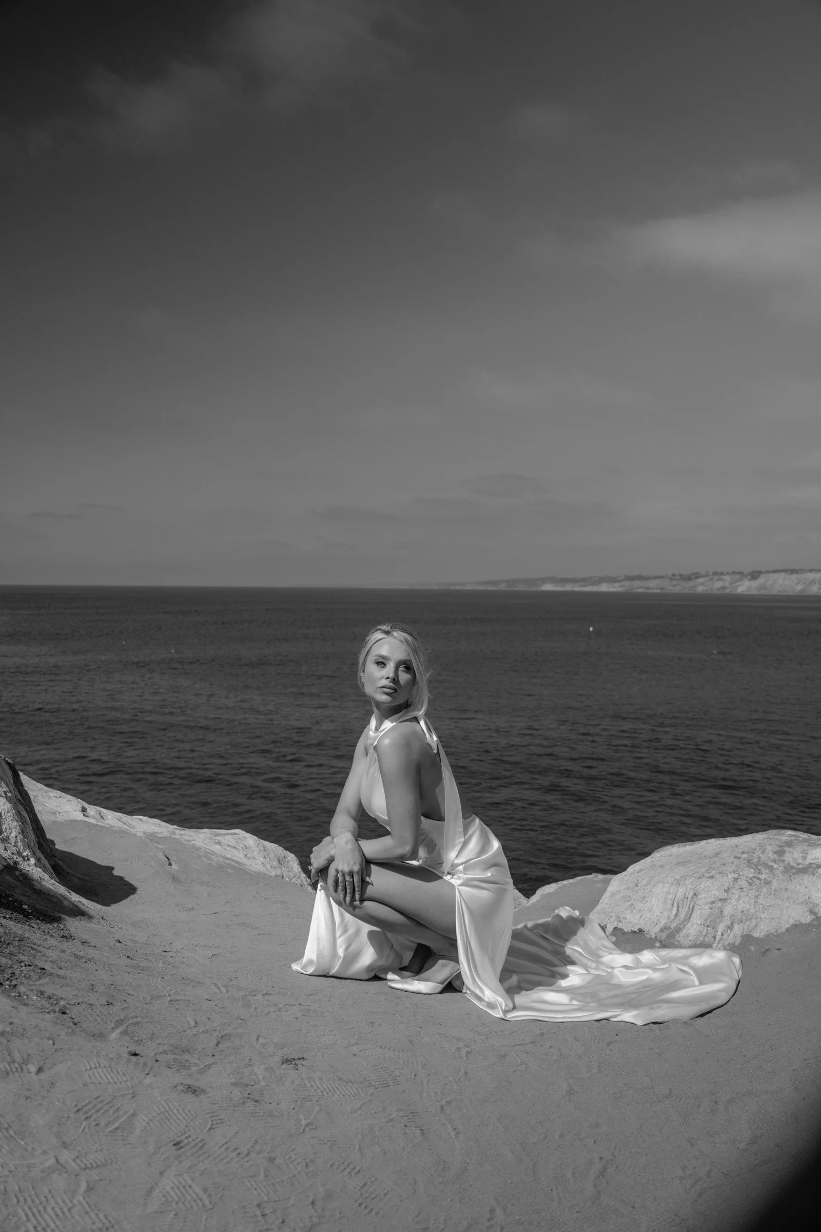 Black-and-white bridal portrait on coastal rocks