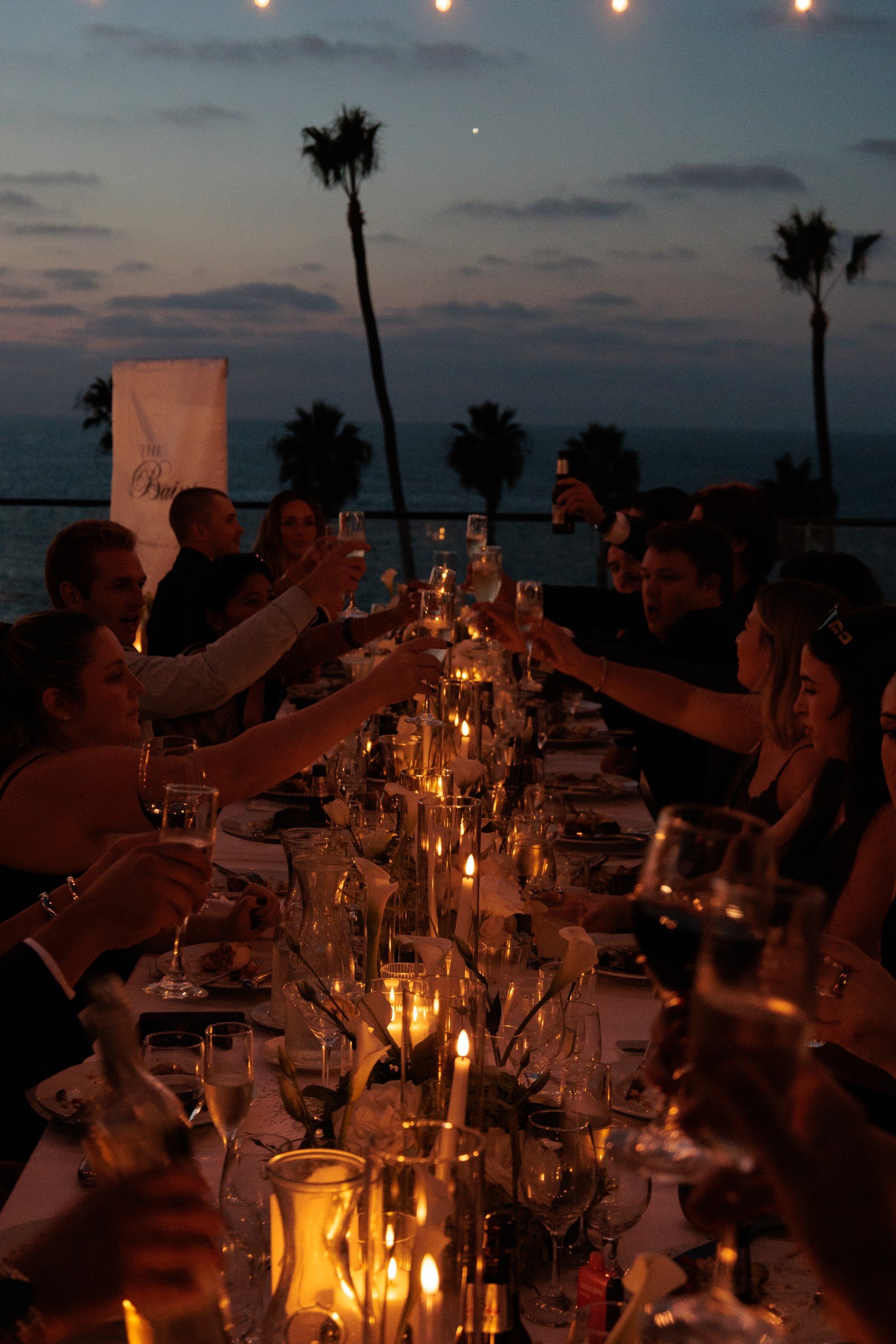 Candlelit wedding dinner overlooking the coast at dusk