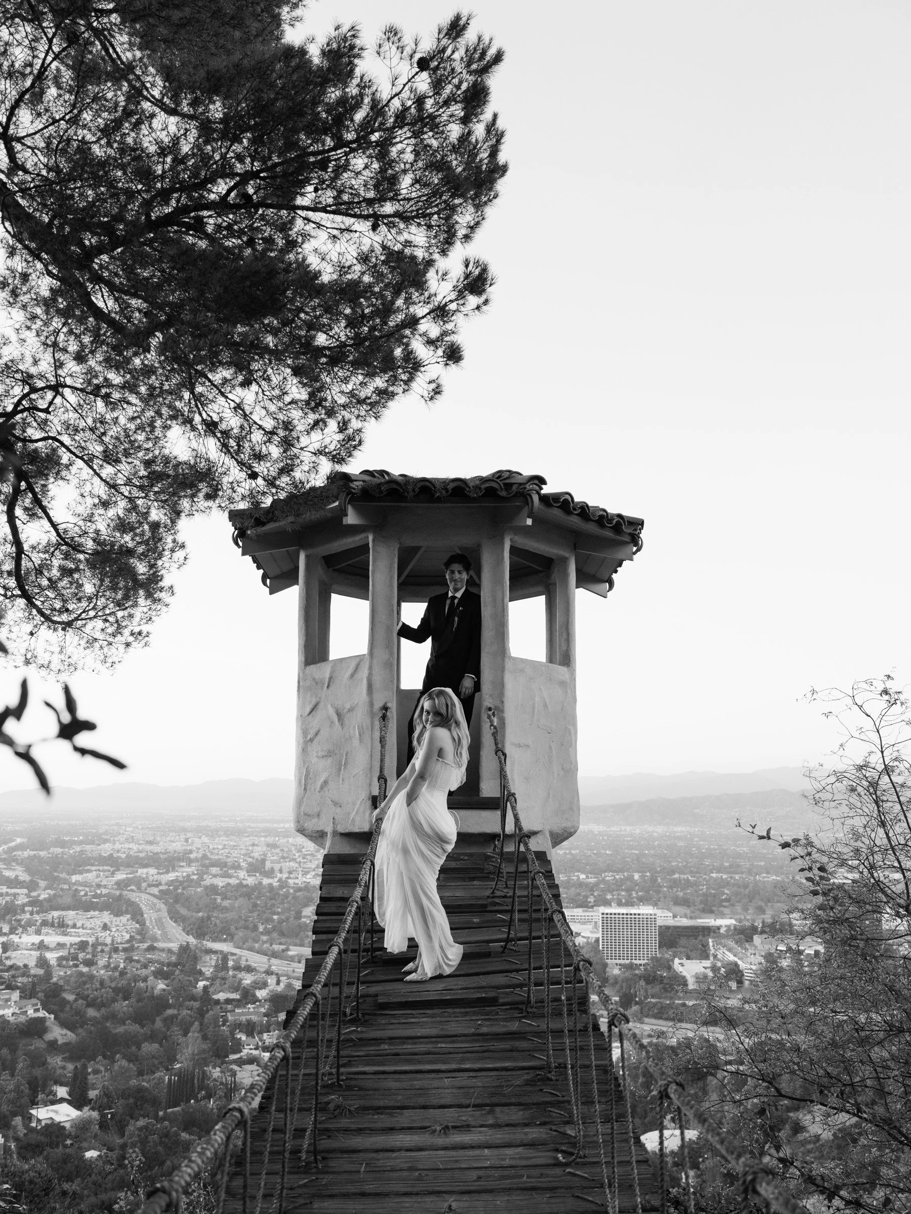 Bride on a garden staircase overlooking the city