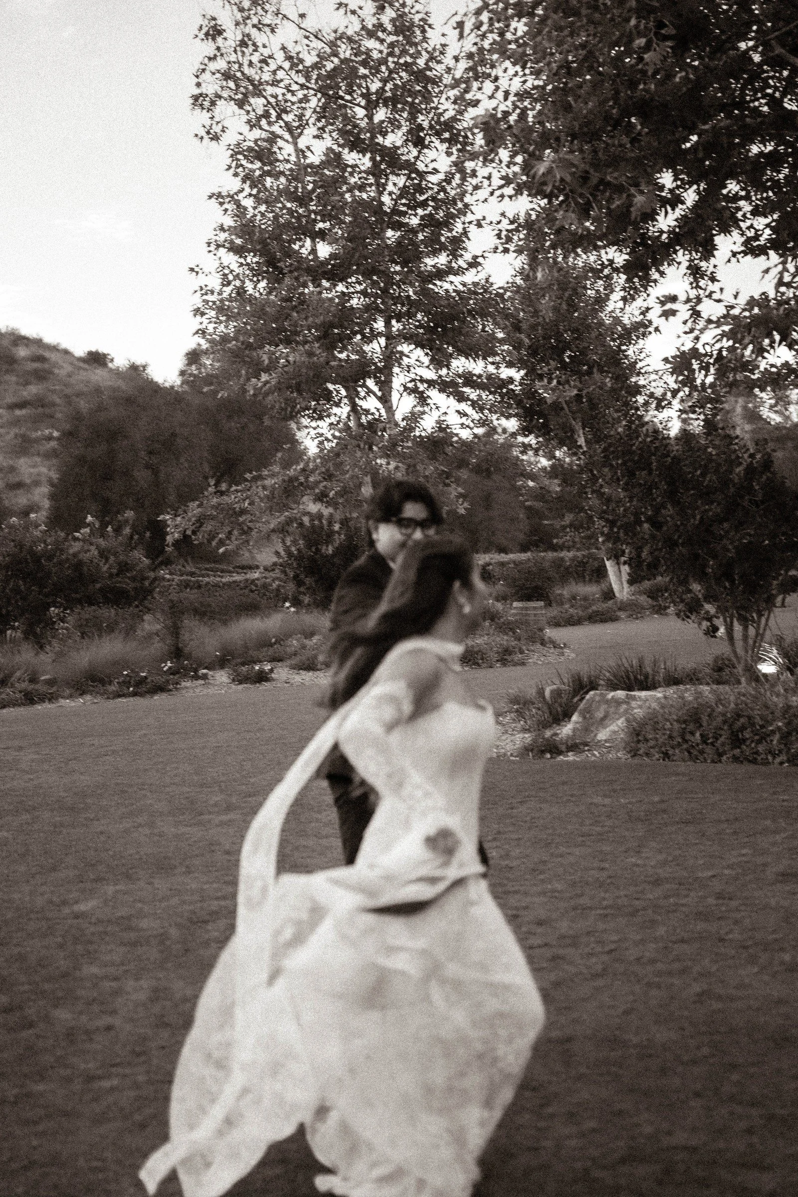 Black-and-white wedding portrait in a garden