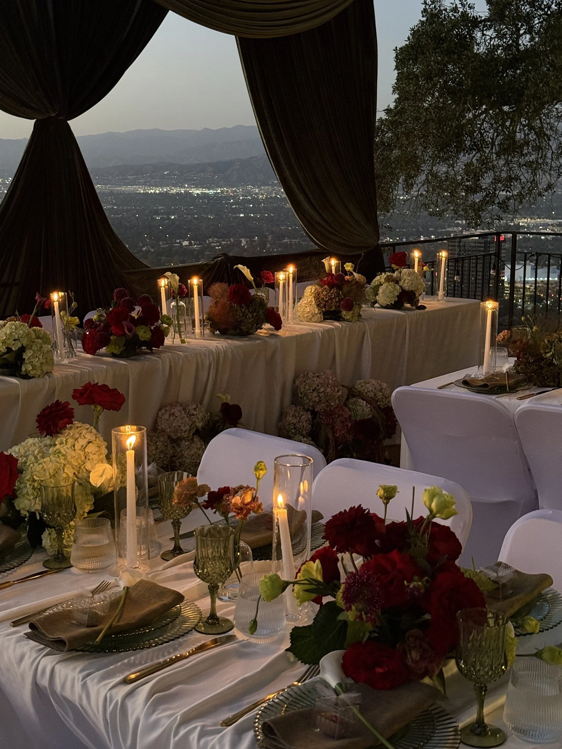 Wedding table framed by dark draping