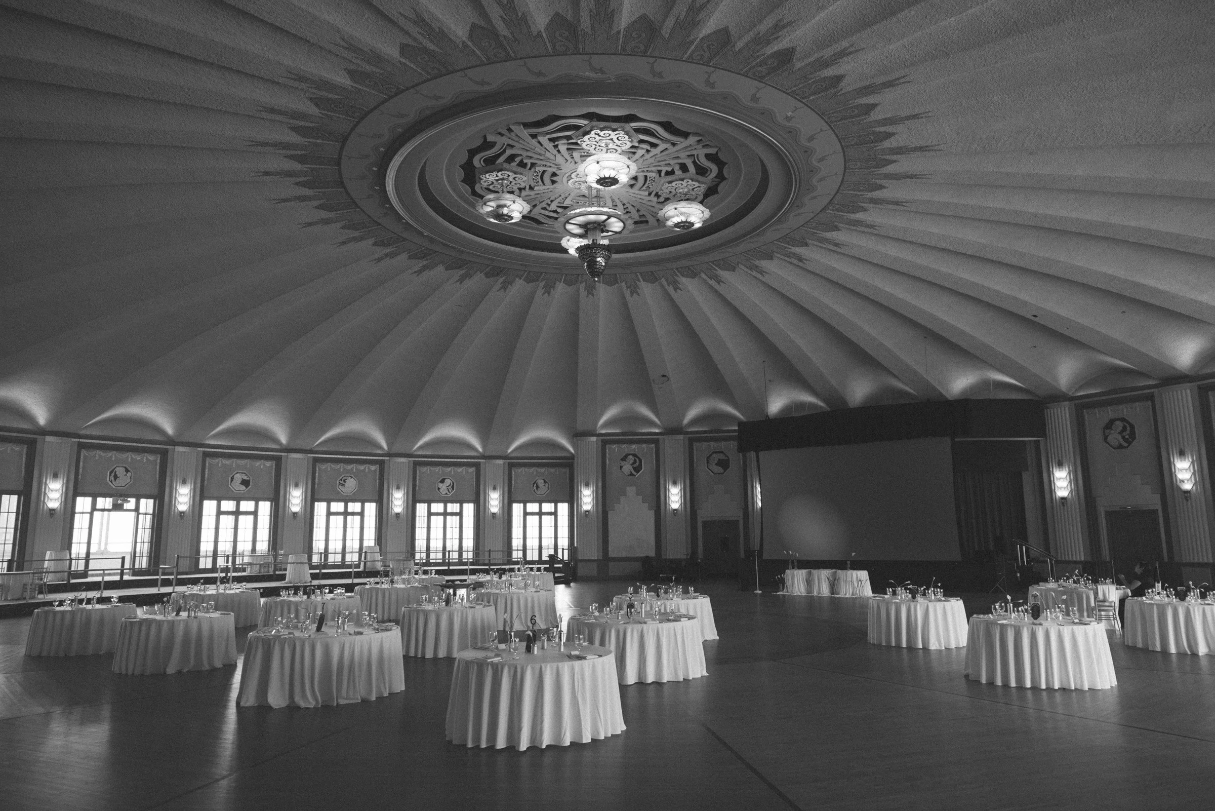 Reception tables beneath an ornate circular ceiling