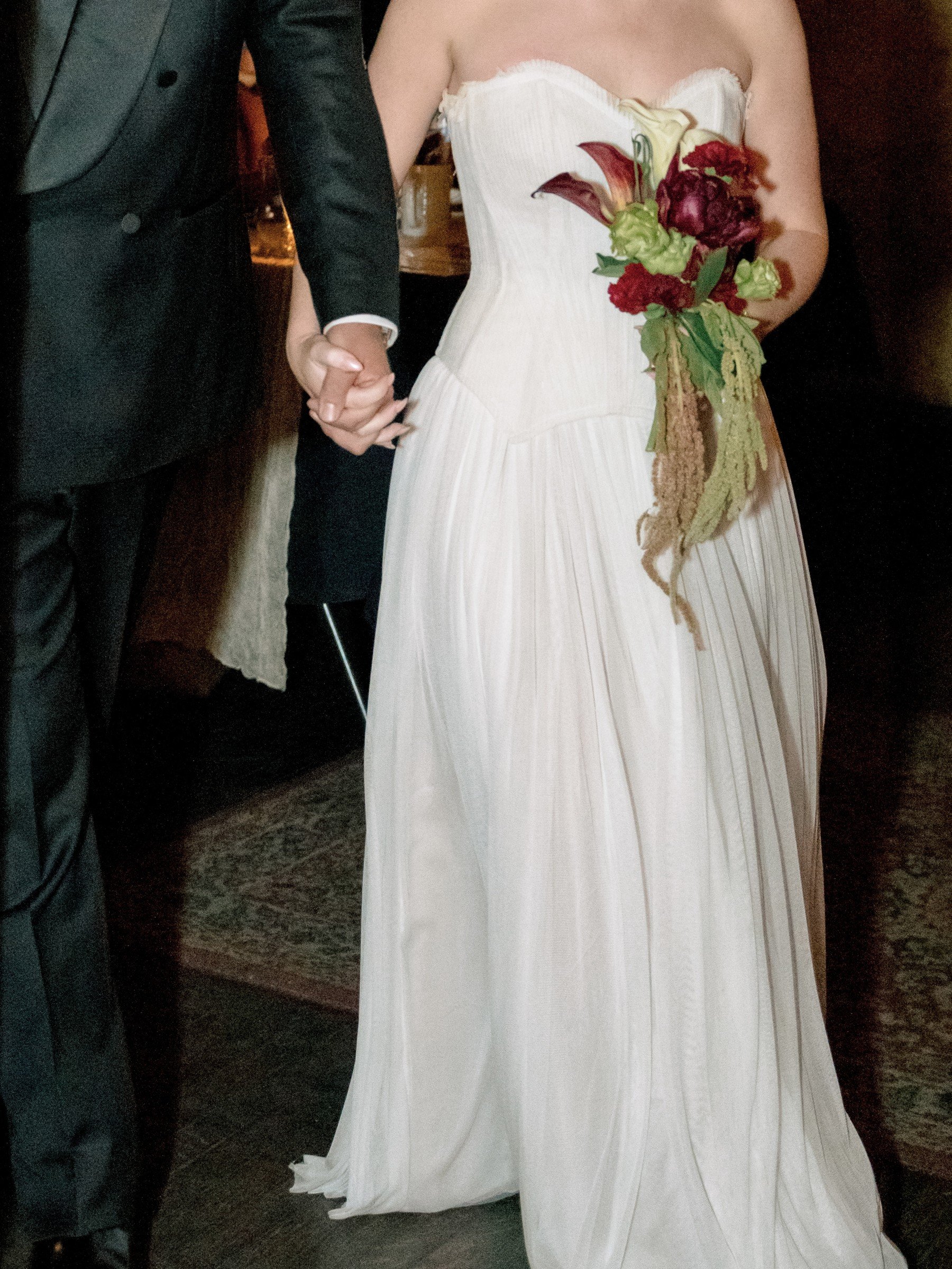 Bride carrying a burgundy bouquet