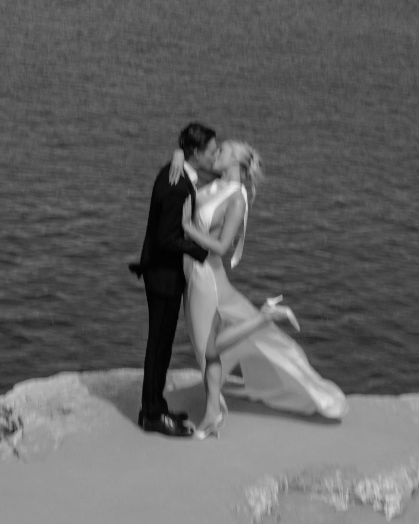 Black-and-white portrait of newlyweds on the coast