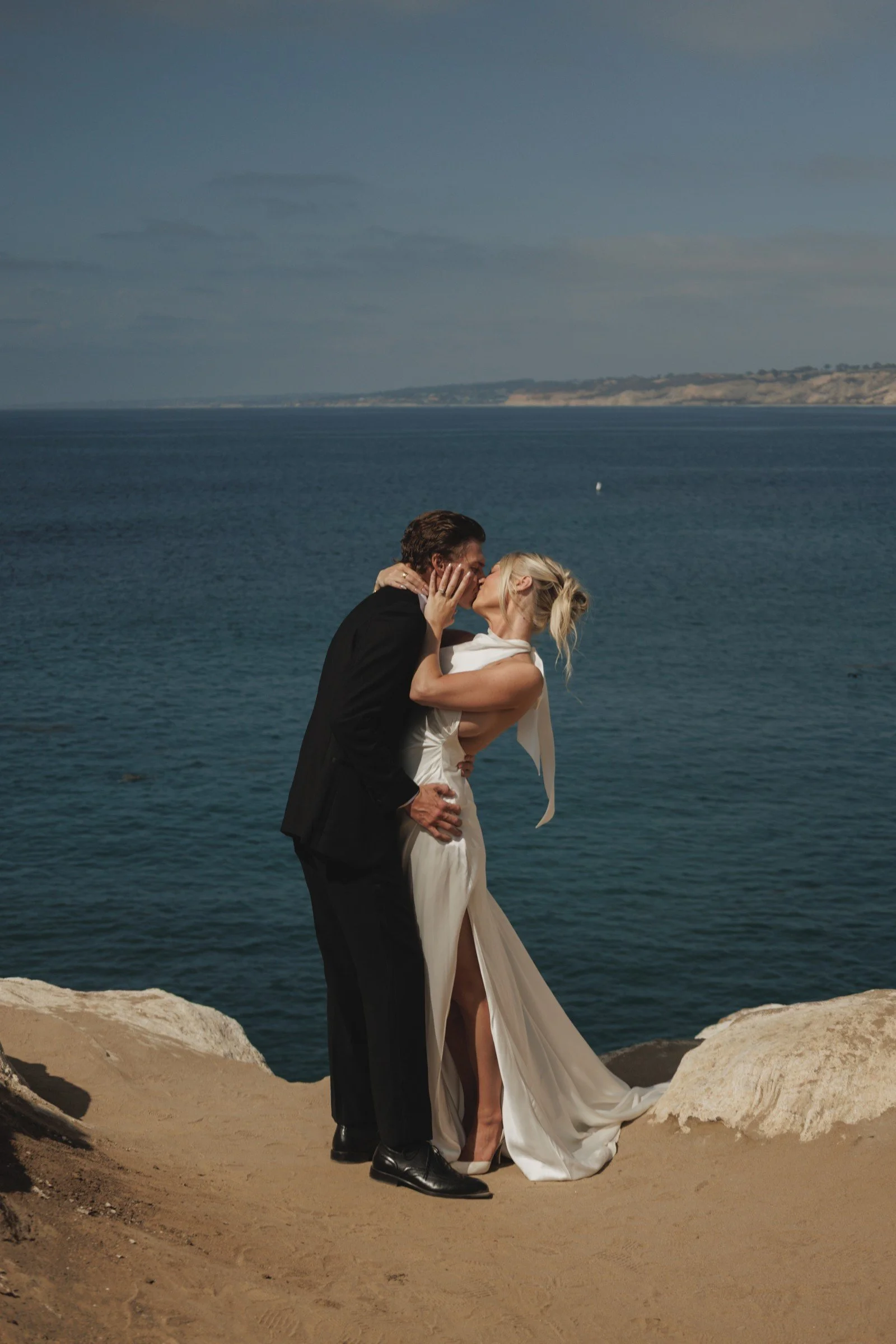 Couple embracing beside the ocean