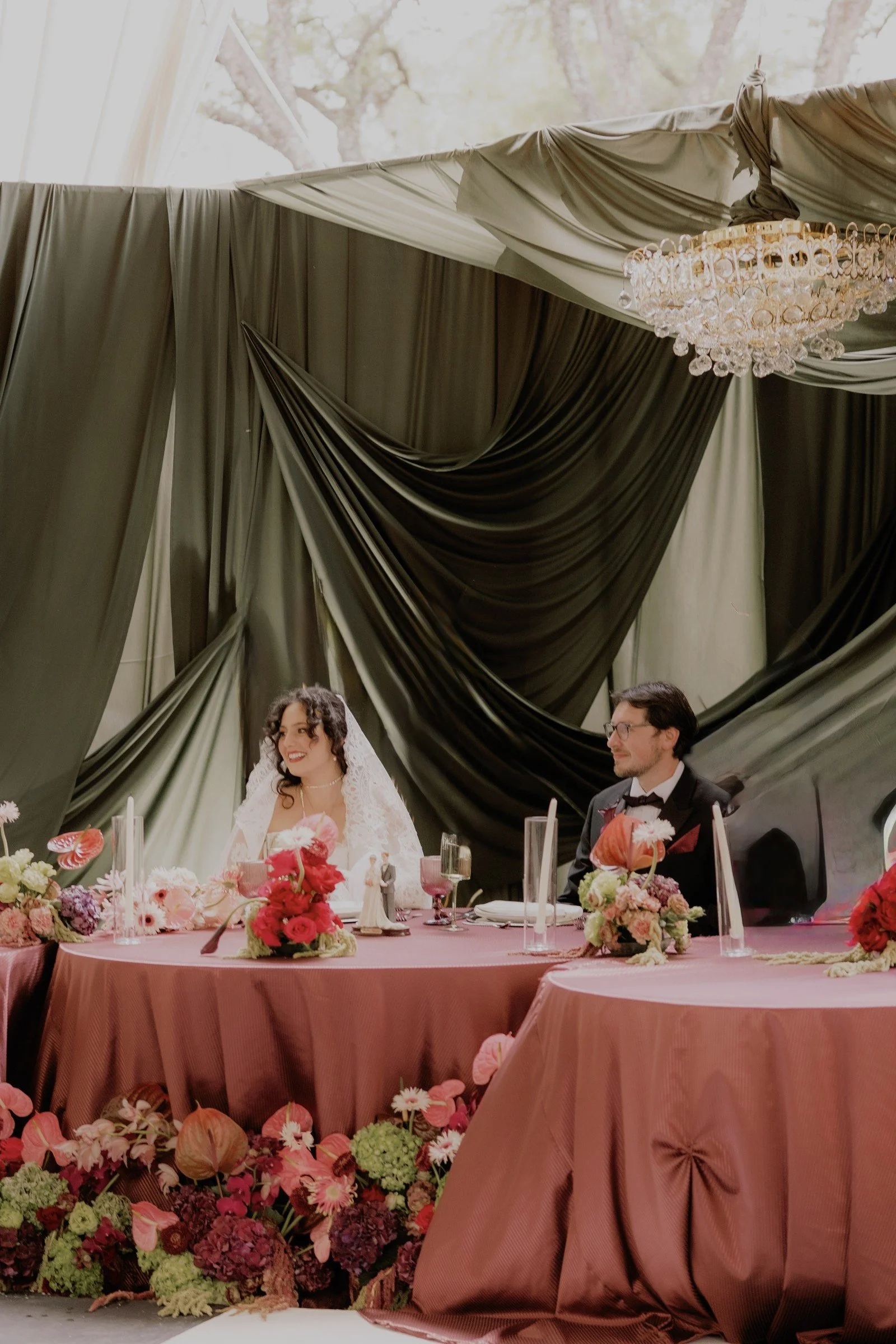 Pink reception table with green and blush draping
