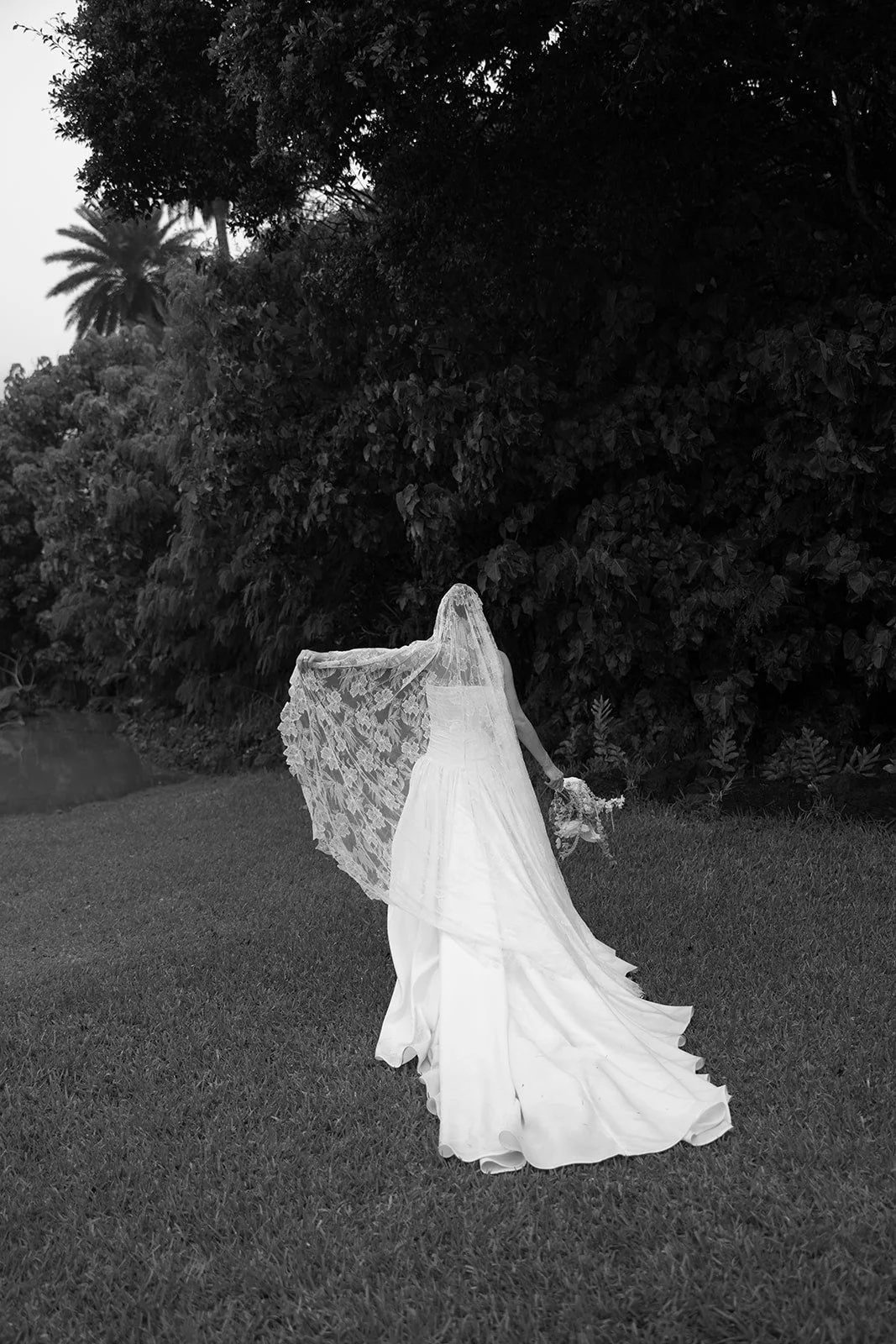 Bride beside tropical greenery