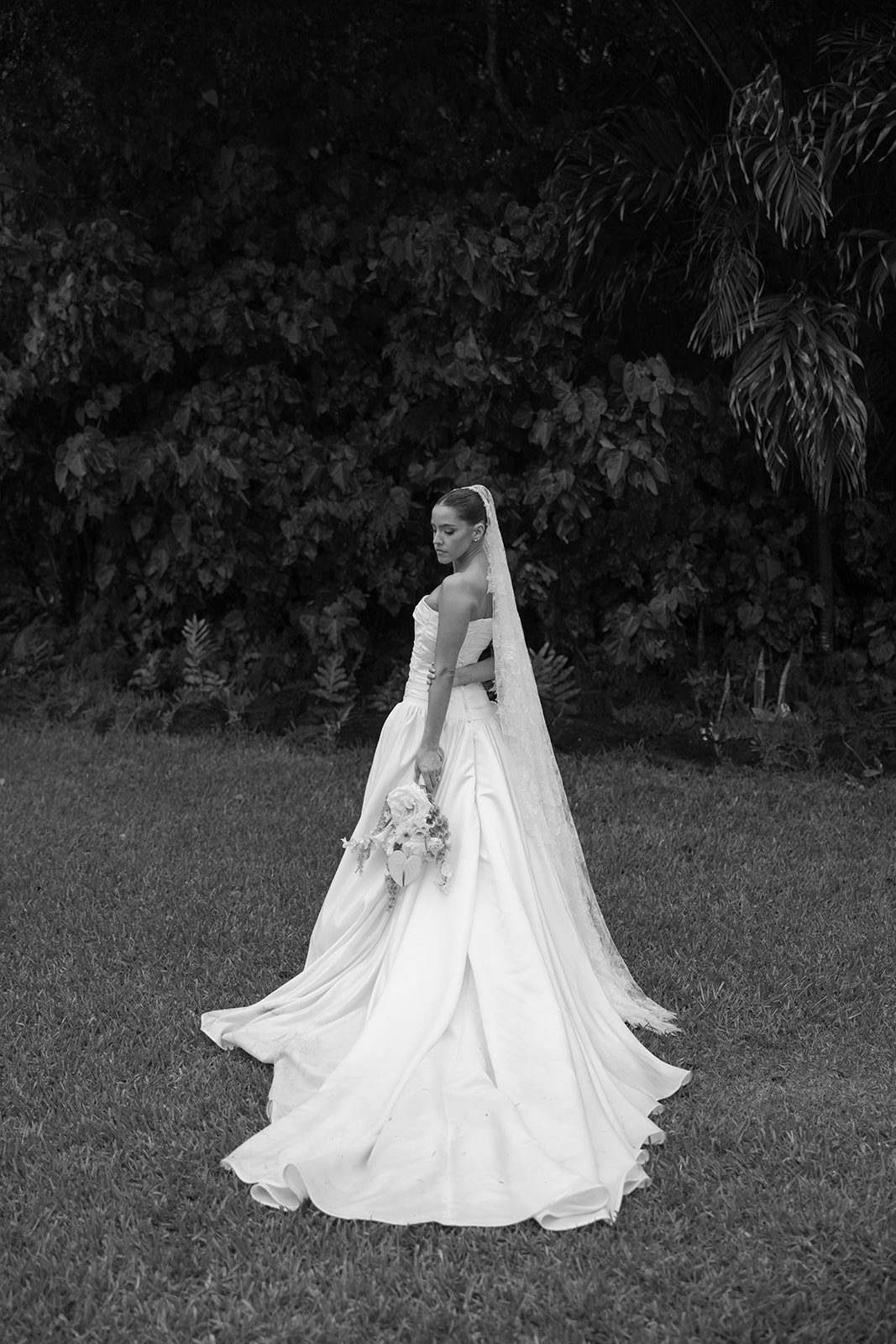 Bride with a flowing veil in black and white