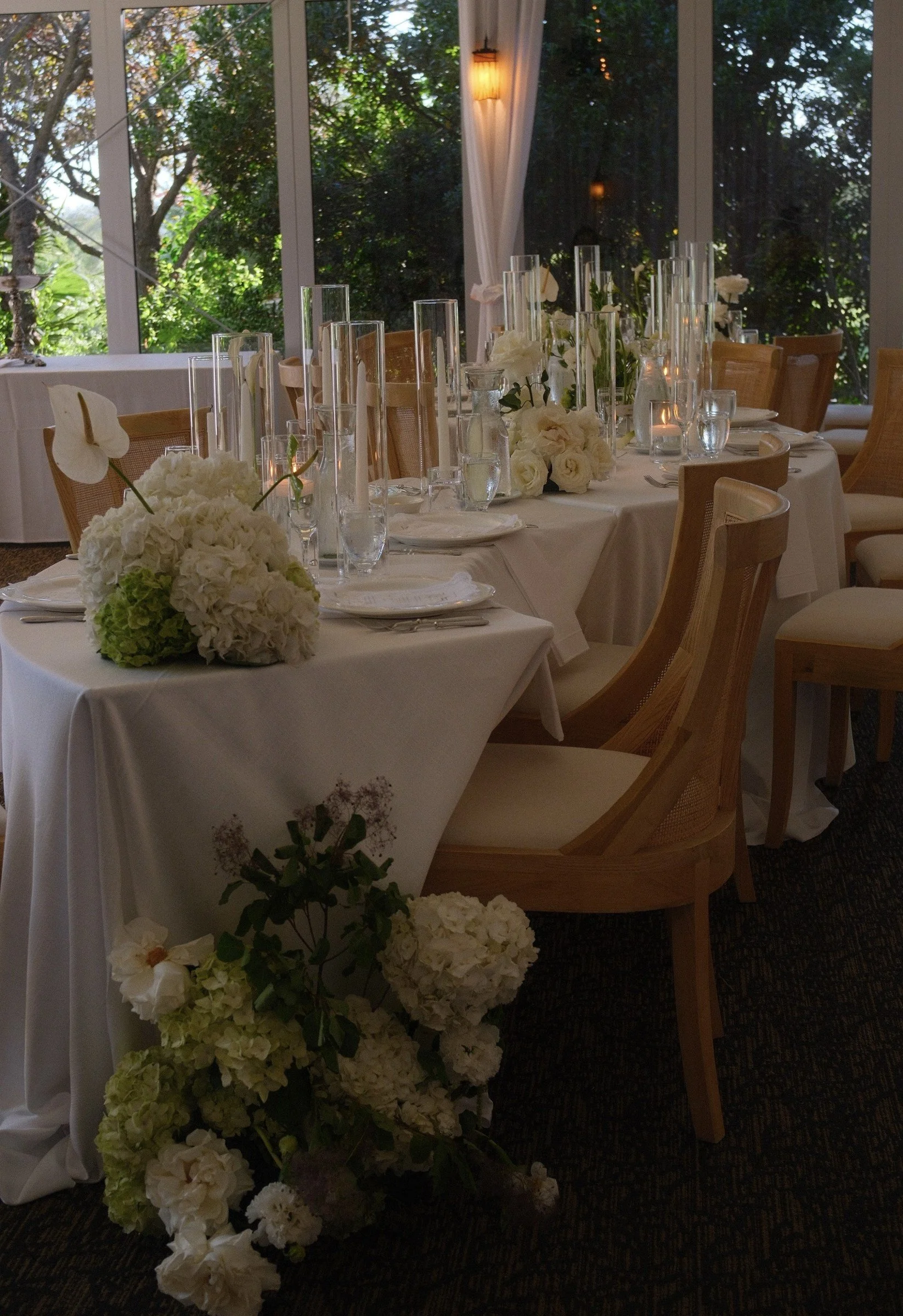 Reception table with white flowers and candleholders
